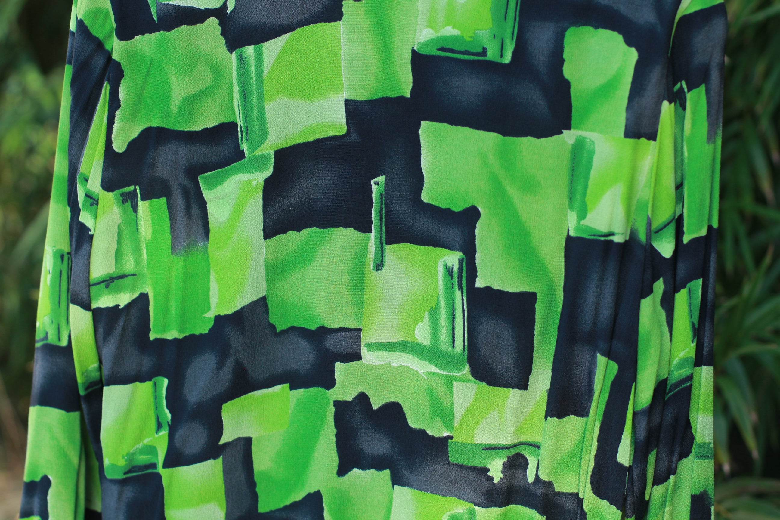 Close-up of green and black multicolor print on vintage Gianni blouse