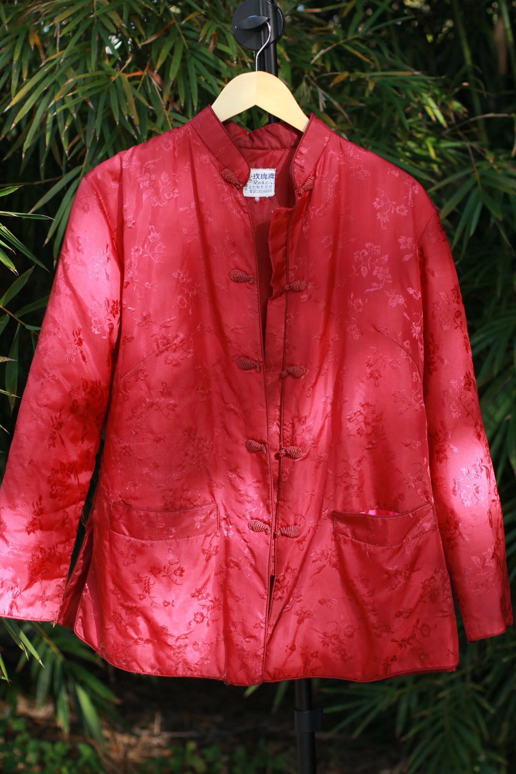 Front view of vintage red floral satin brocade Chinese-style quilted jacket