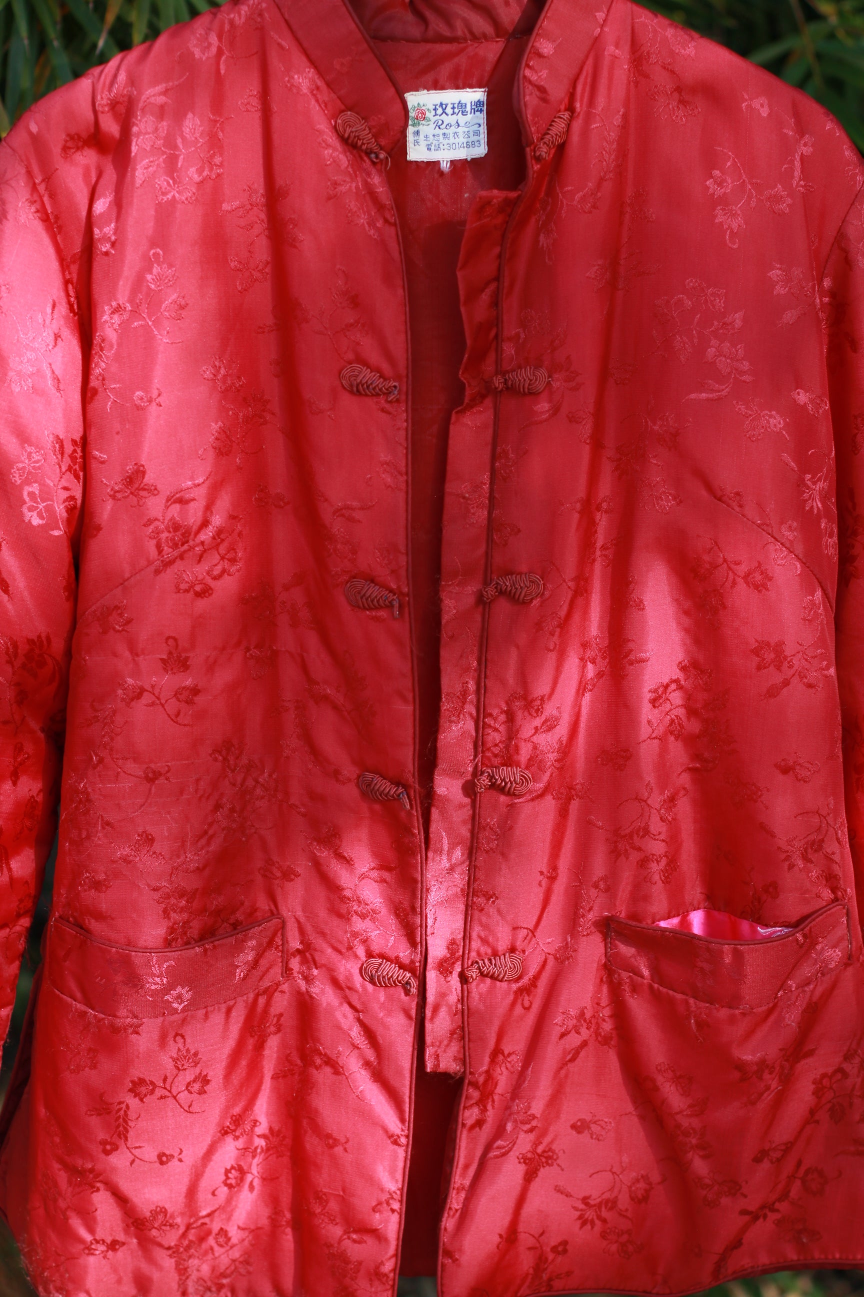 Close-up detail of floral brocade and frog closures