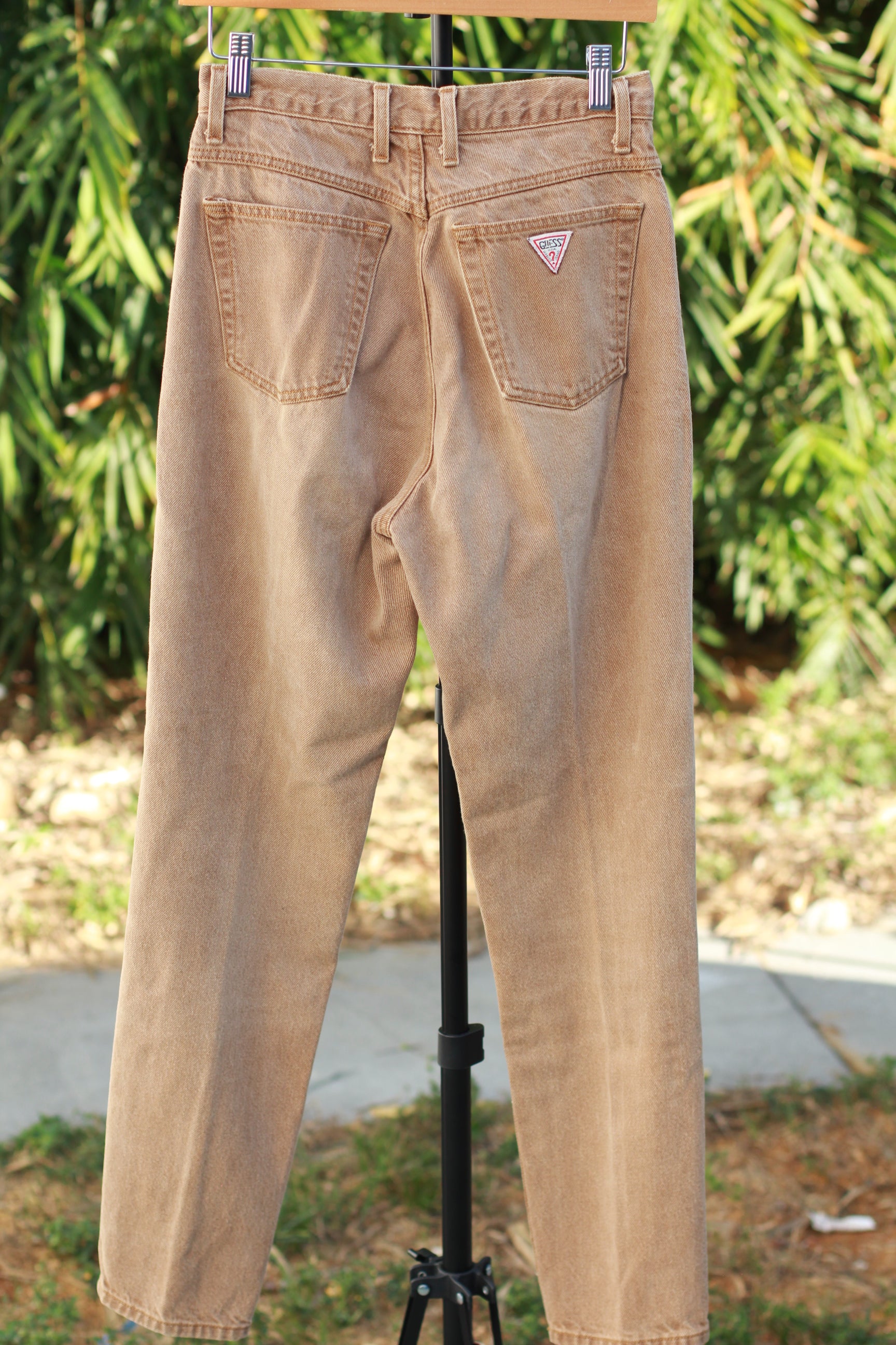 Back view of washed tan vintage Guess skinny jeans