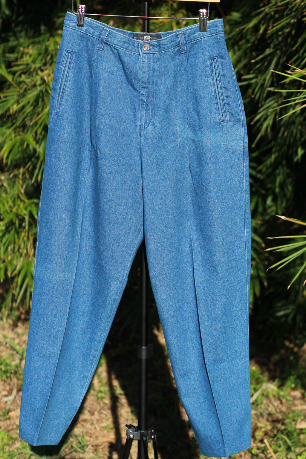 Front view of vintage 90s Lee pleated tapered jeans in mid blue wash