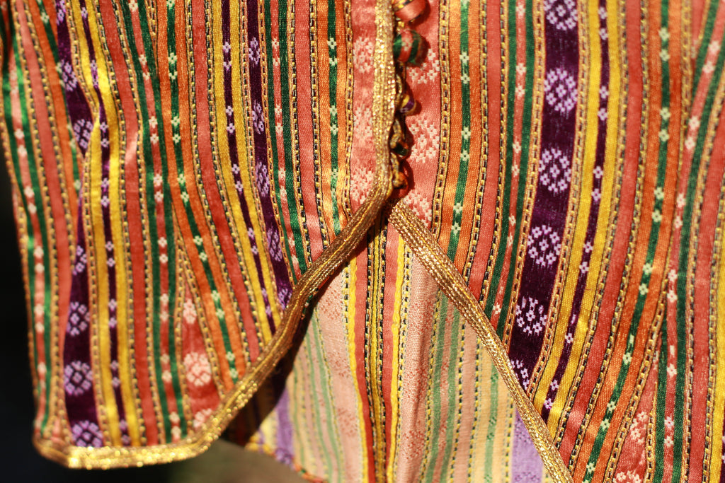 Close-up of gold lurex and floral motifs on antique silk jacket