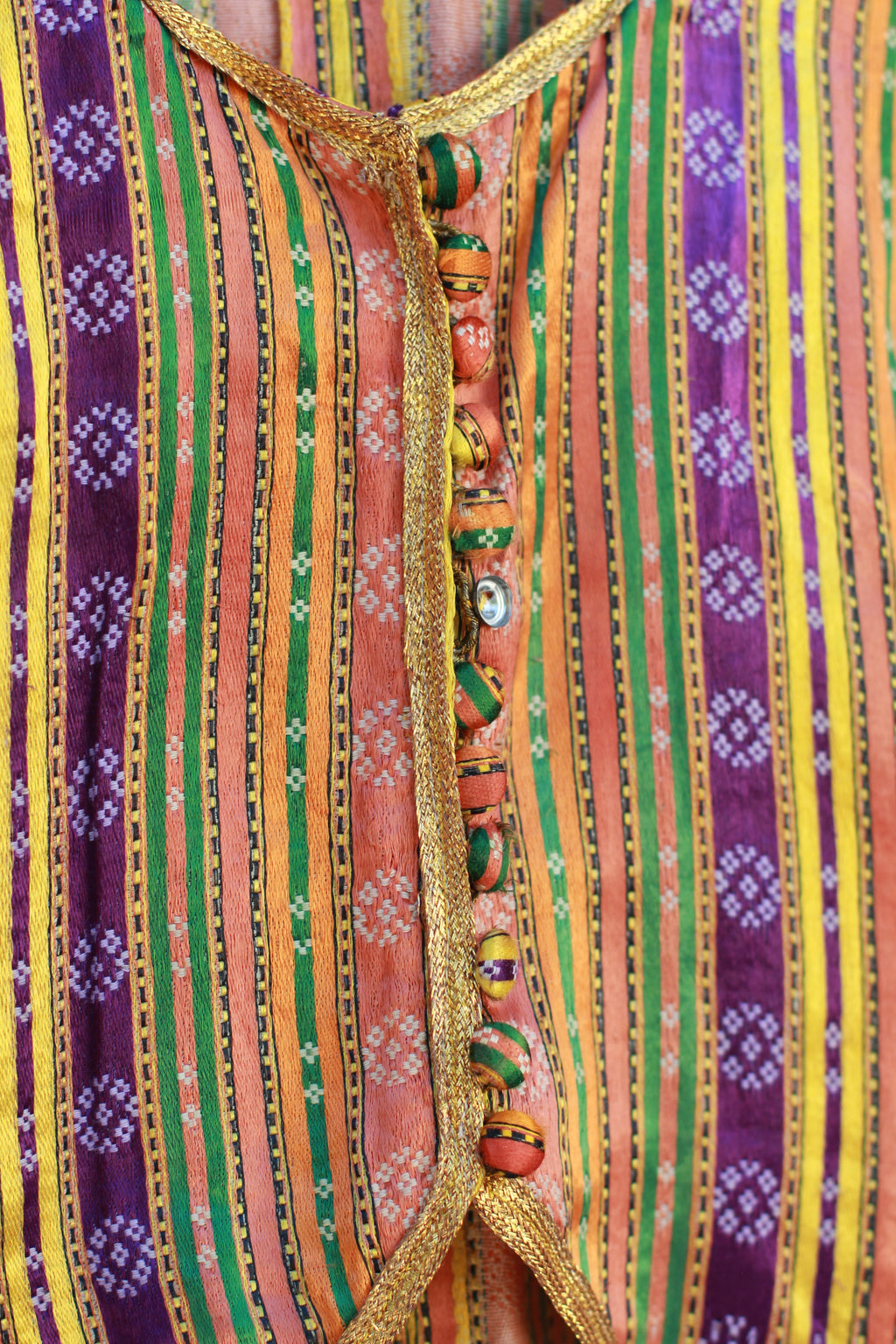 Detail of hand-tailored silk jacket with button closure