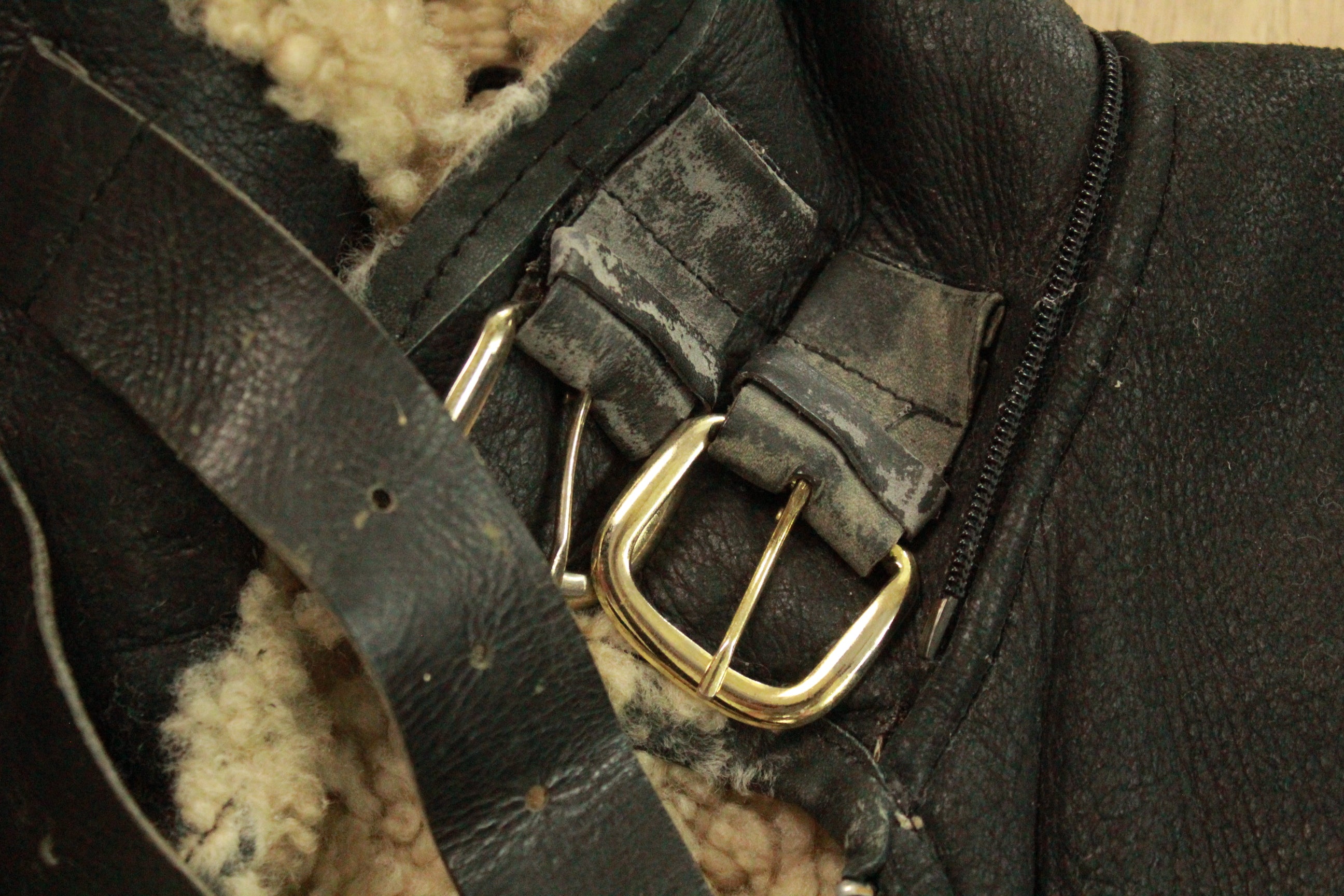 Close-up of natural wear on neck buckles on USA Made Vintage Black B3 Shearling Bomber Jacket