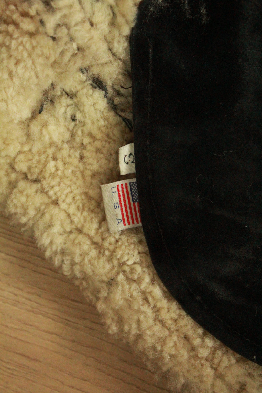 Close-up of size tag and USA Made tag on Vintage Black B3 Shearling Bomber Jacket