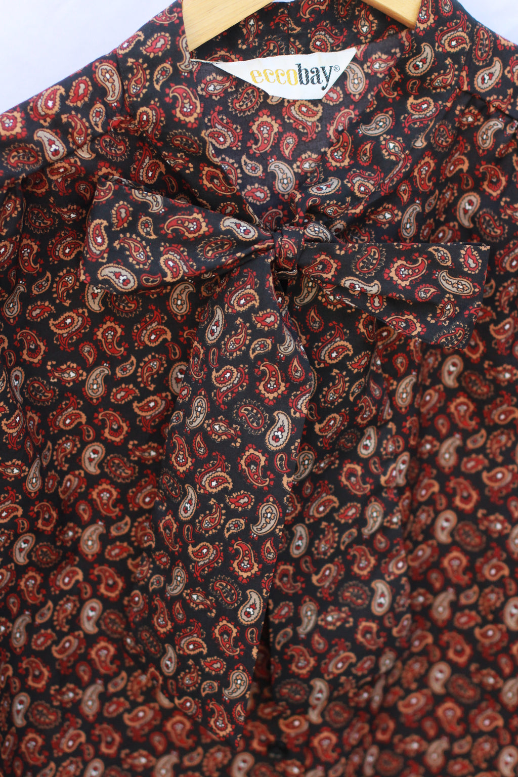 Detail of pussy-bow necktie on vintage paisley blouse