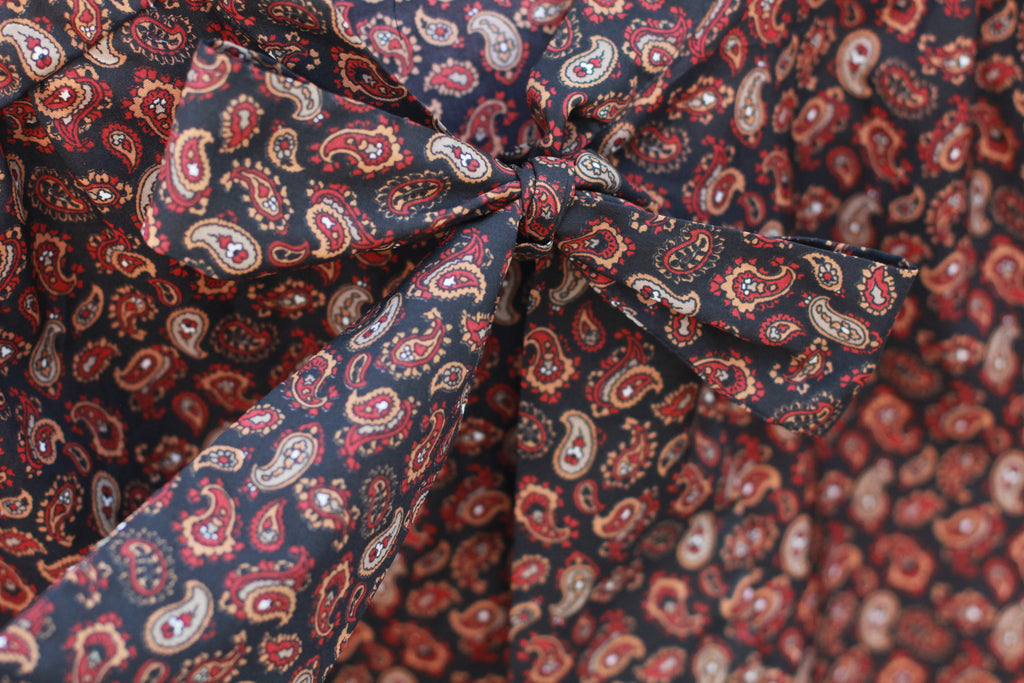 Detail of pussy-bow necktie on vintage paisley blouse