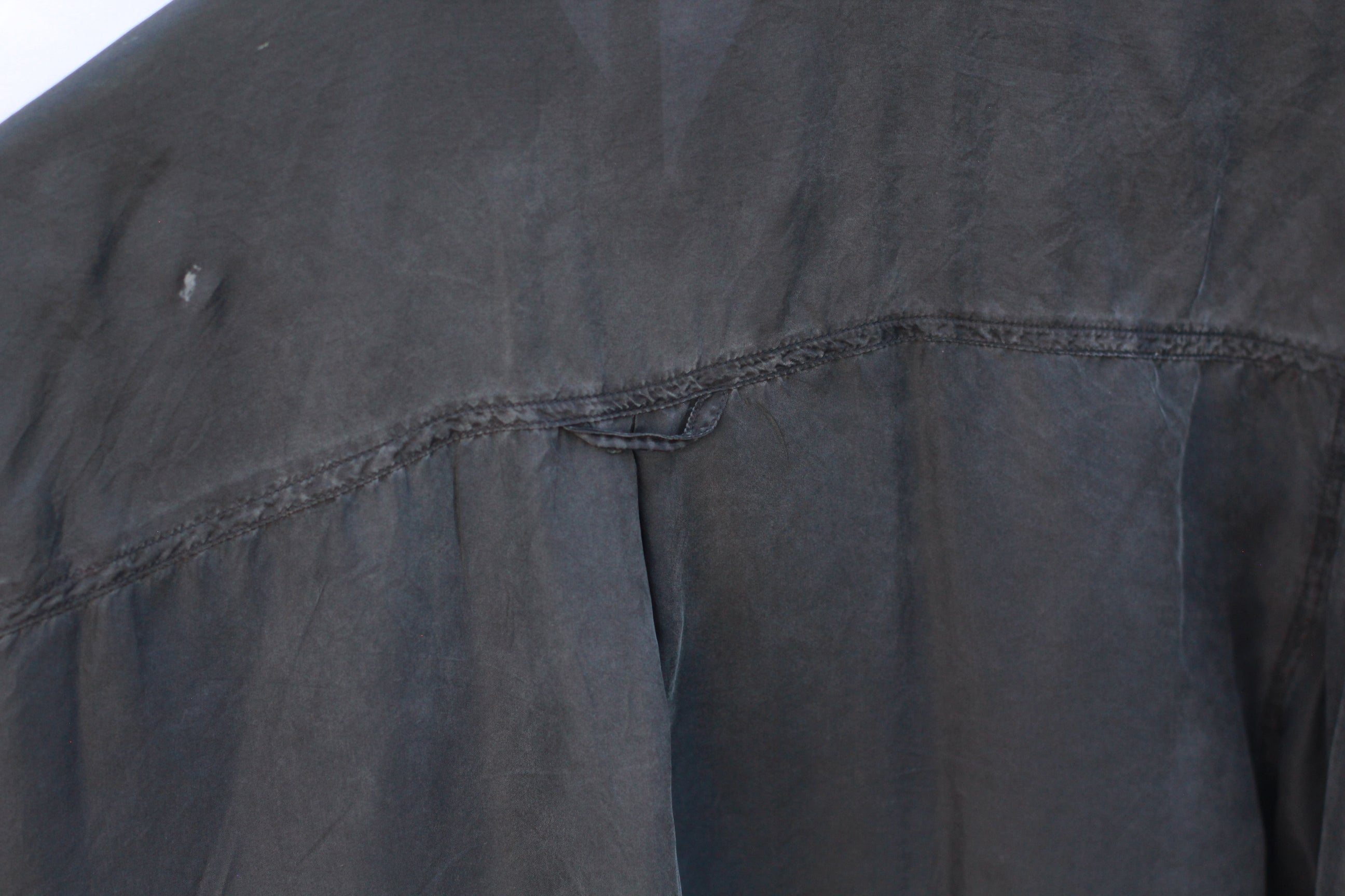 Detail of naturally faded silk fabric on 1970s shirt