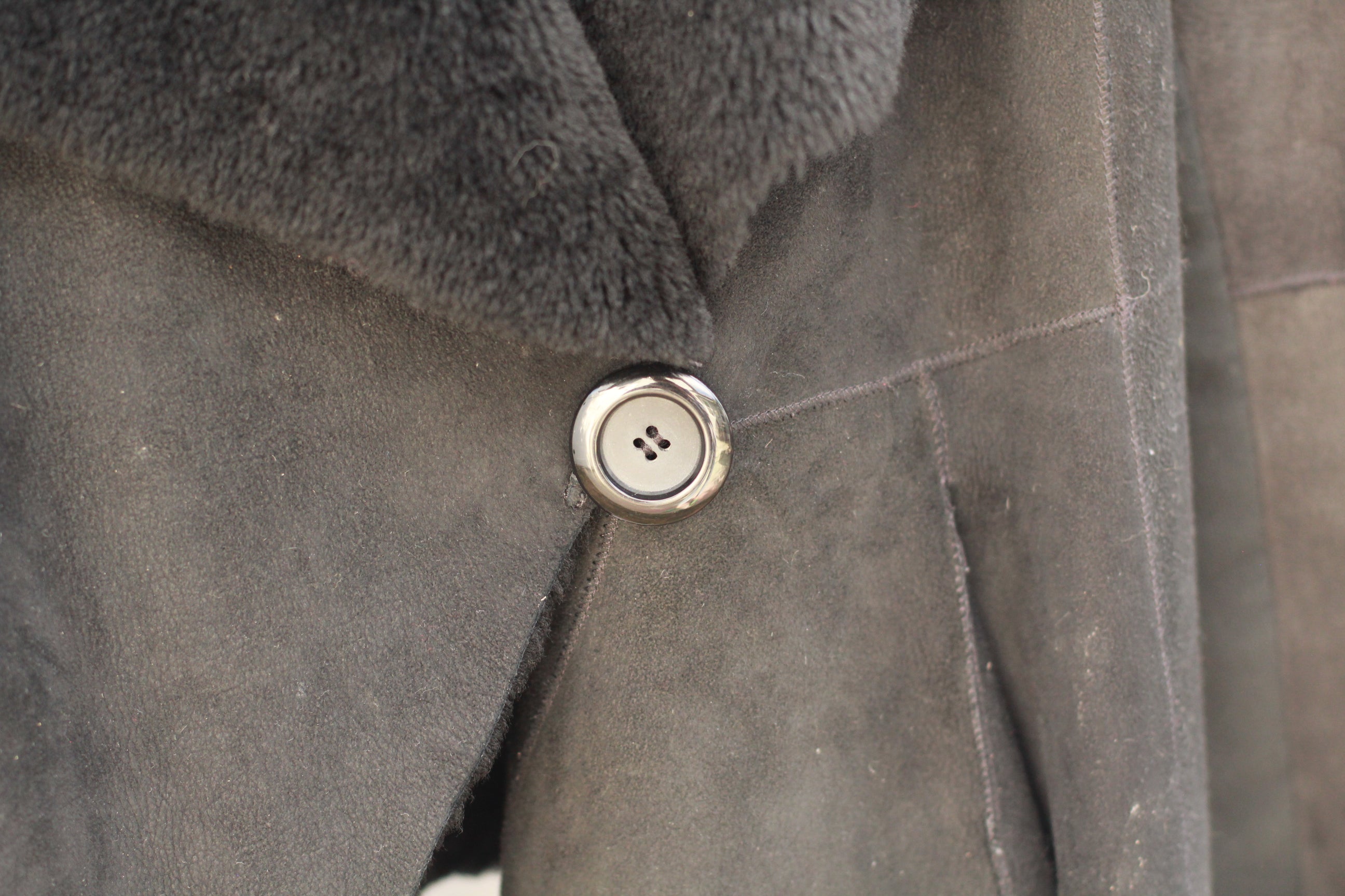 Detail of single waist button and plush interior lining