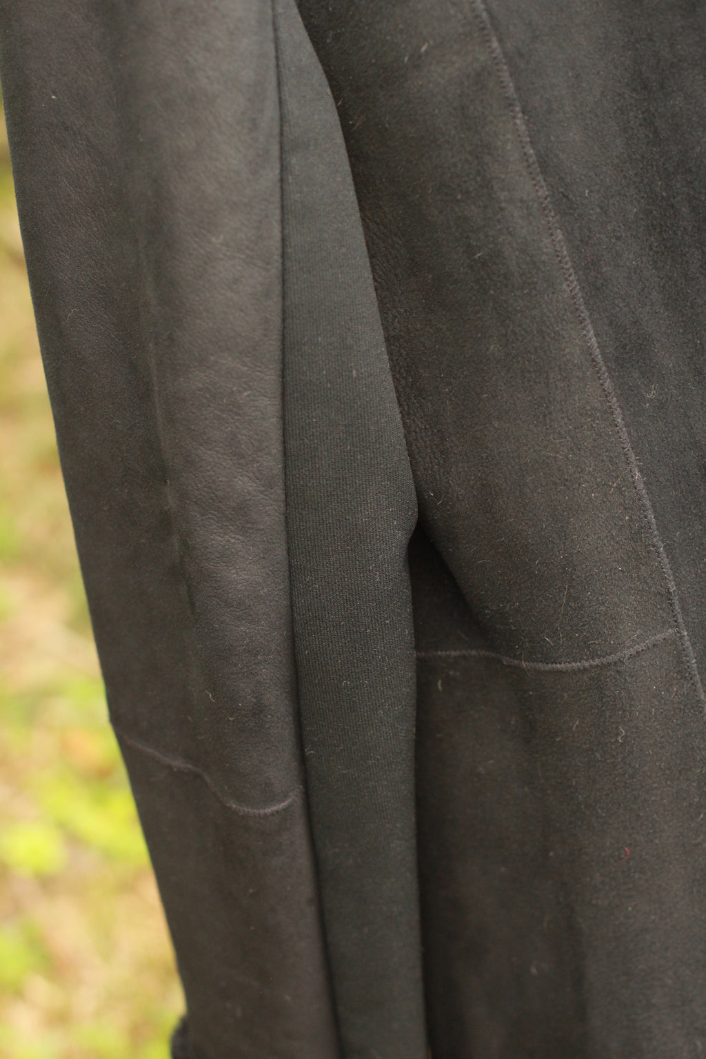 side view of black suede-style winter coat