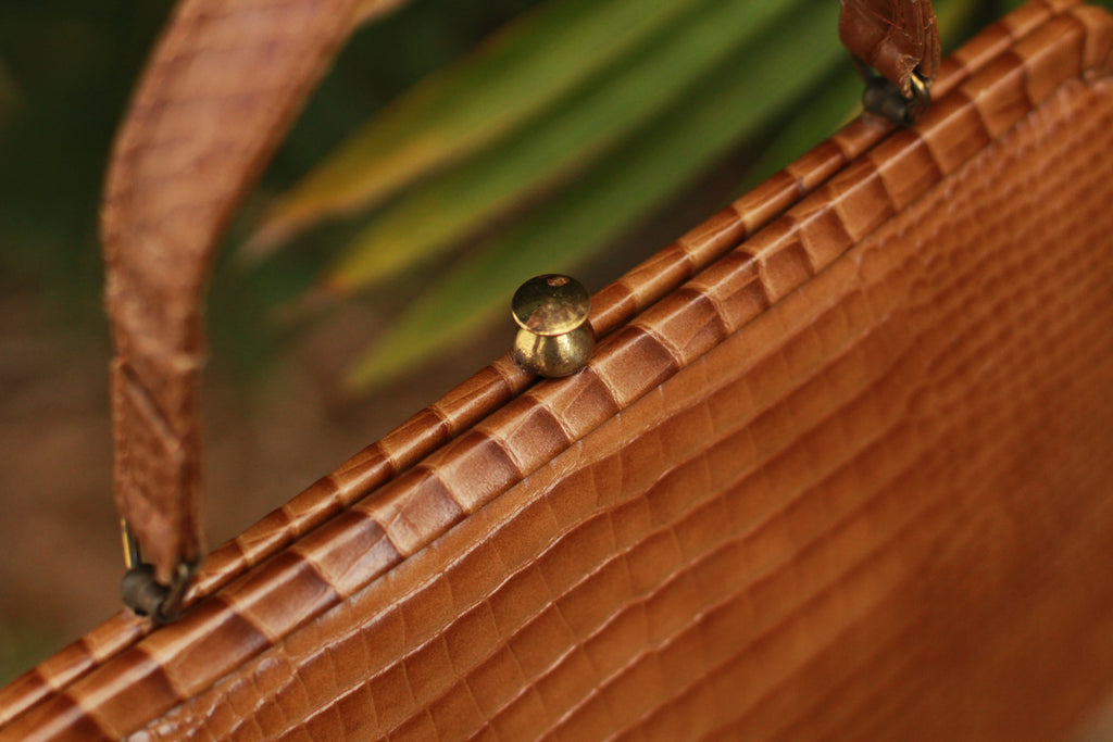 Gold-toned clasp detail on vintage structured leather handbag