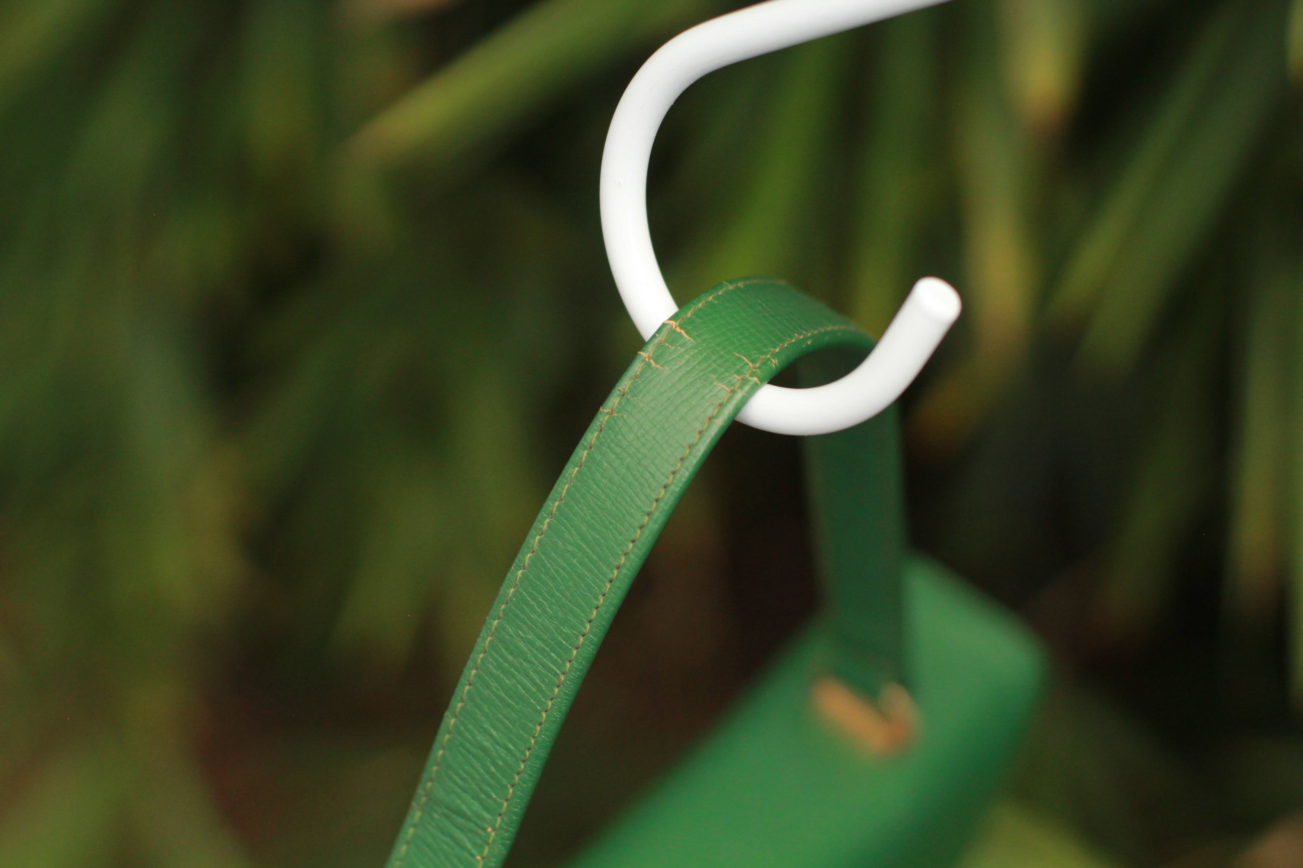 Handle detail showing minor natural wear on vintage green handbag
