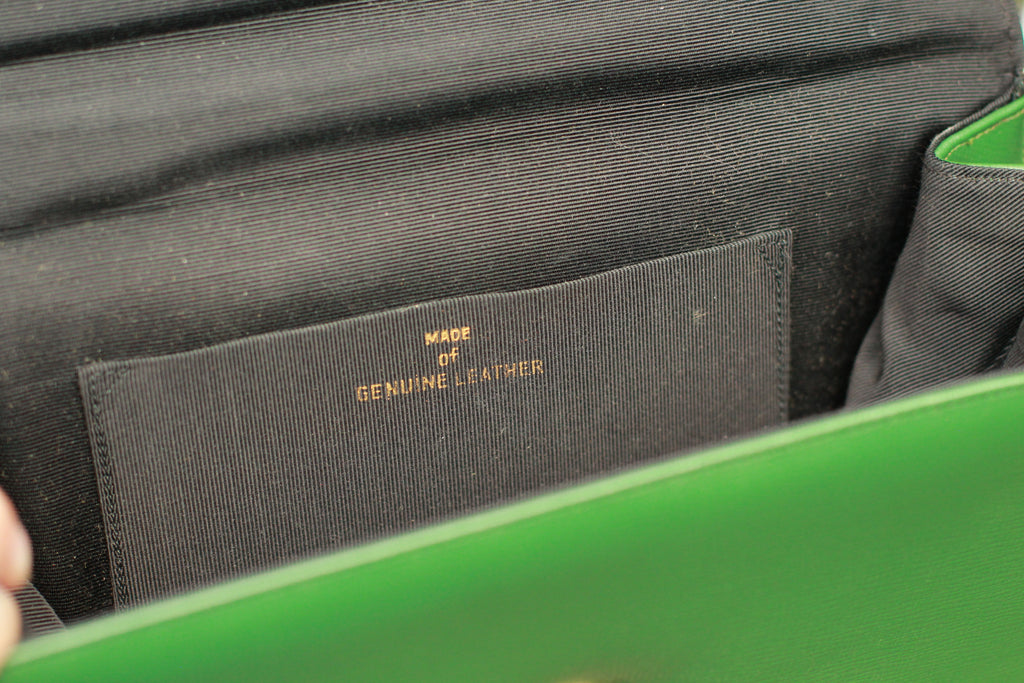 Interior of vintage green leather purse with genuine leather marking