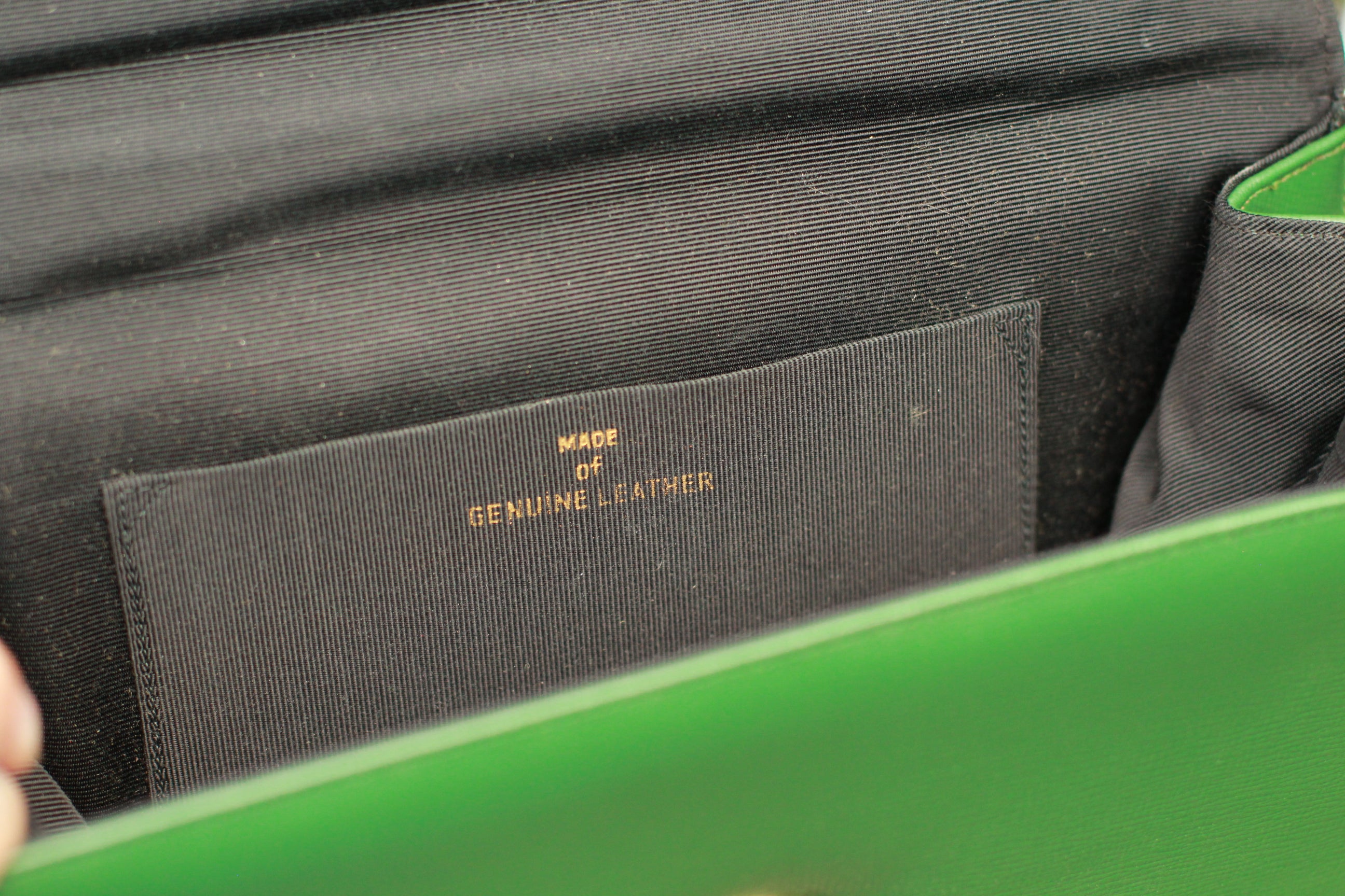 Interior of vintage green leather purse with genuine leather marking