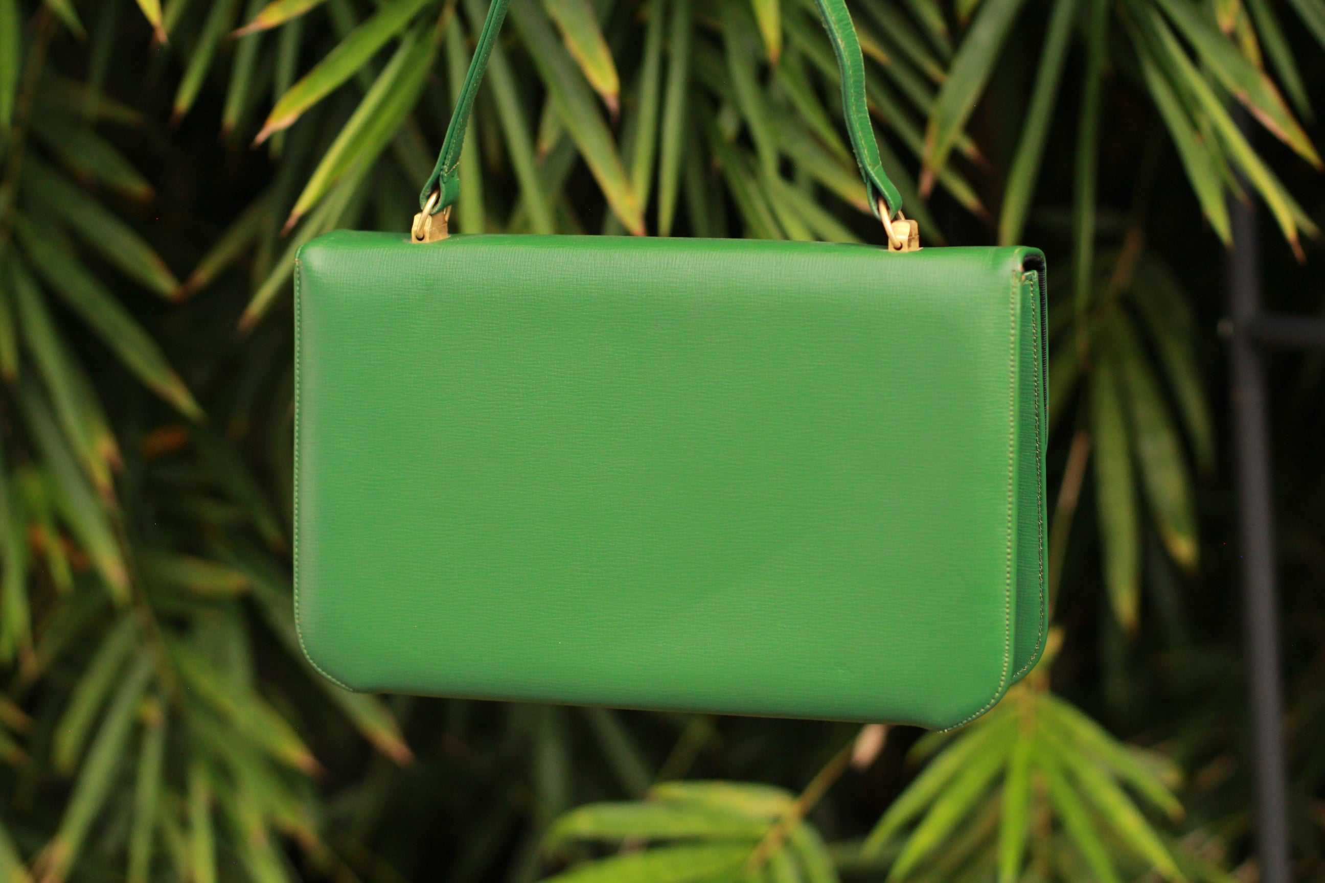 Back view of vintage 1990s green leather handbag