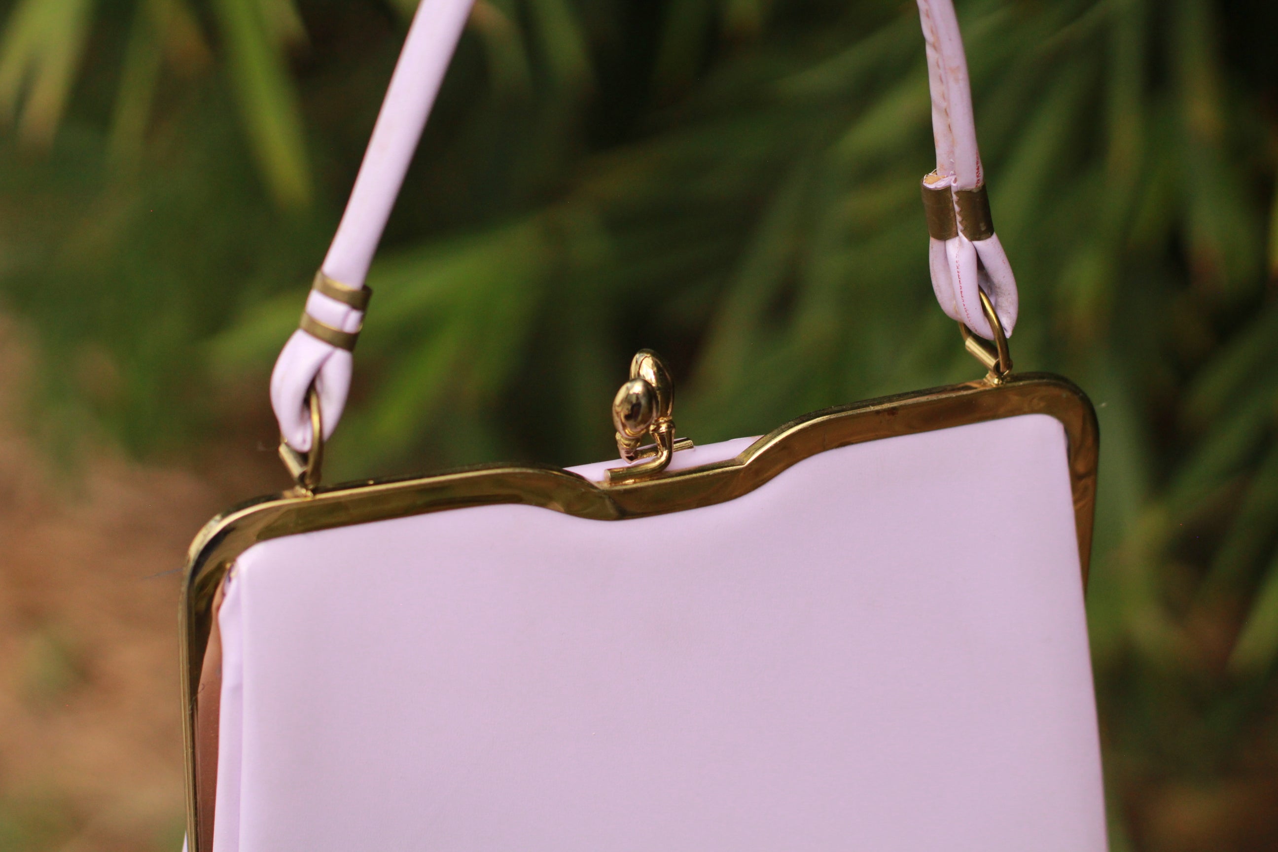 Detail of kiss-lock clasp and gold hardware