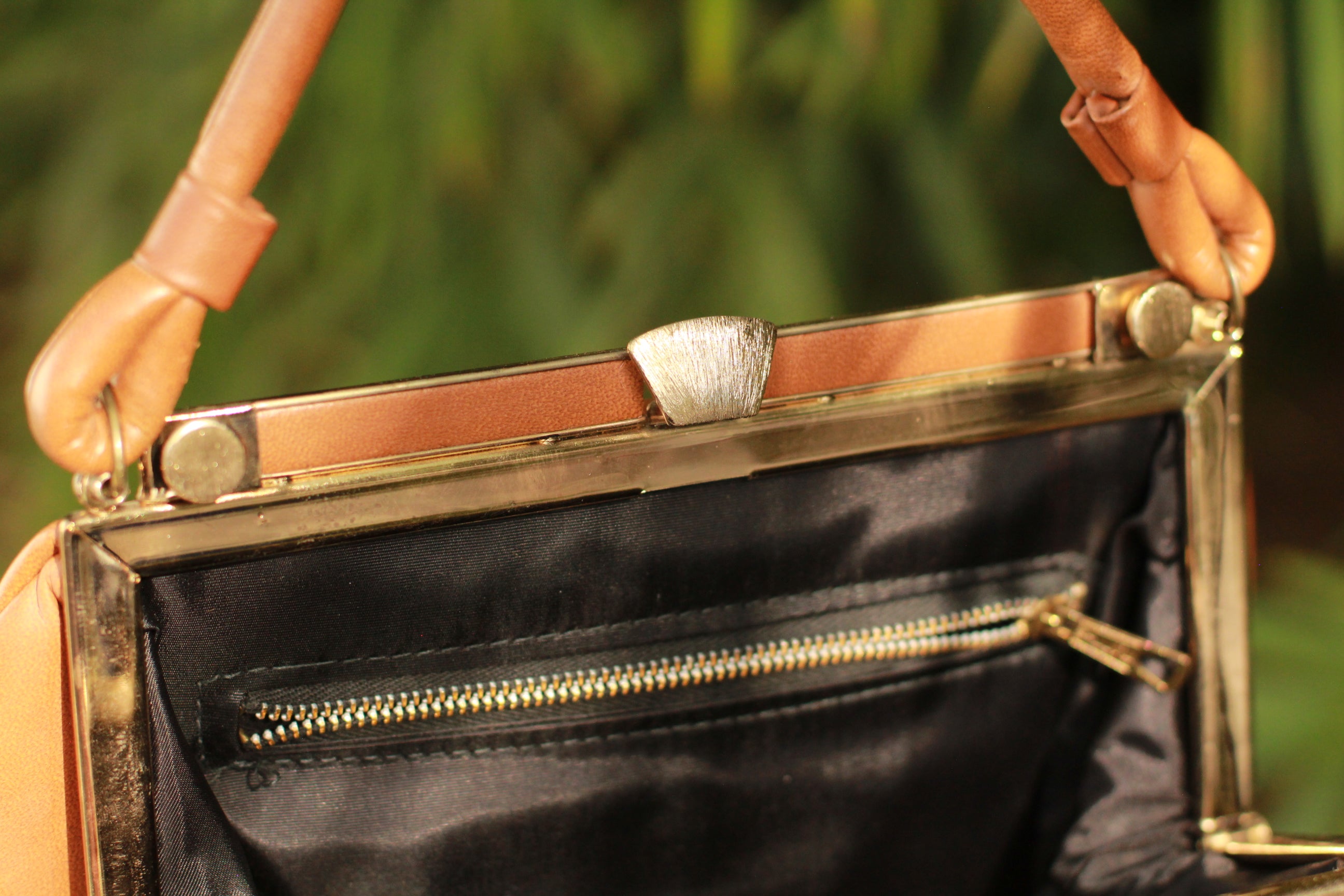 Close-up of gold-tone clasp and hardware inside view