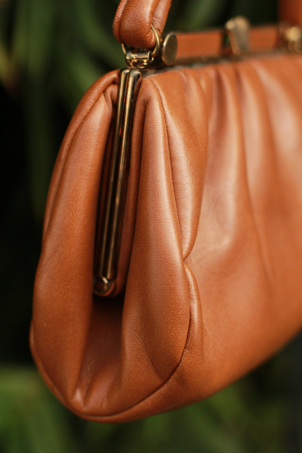 Side view showing soft shape of cognac faux leather purse