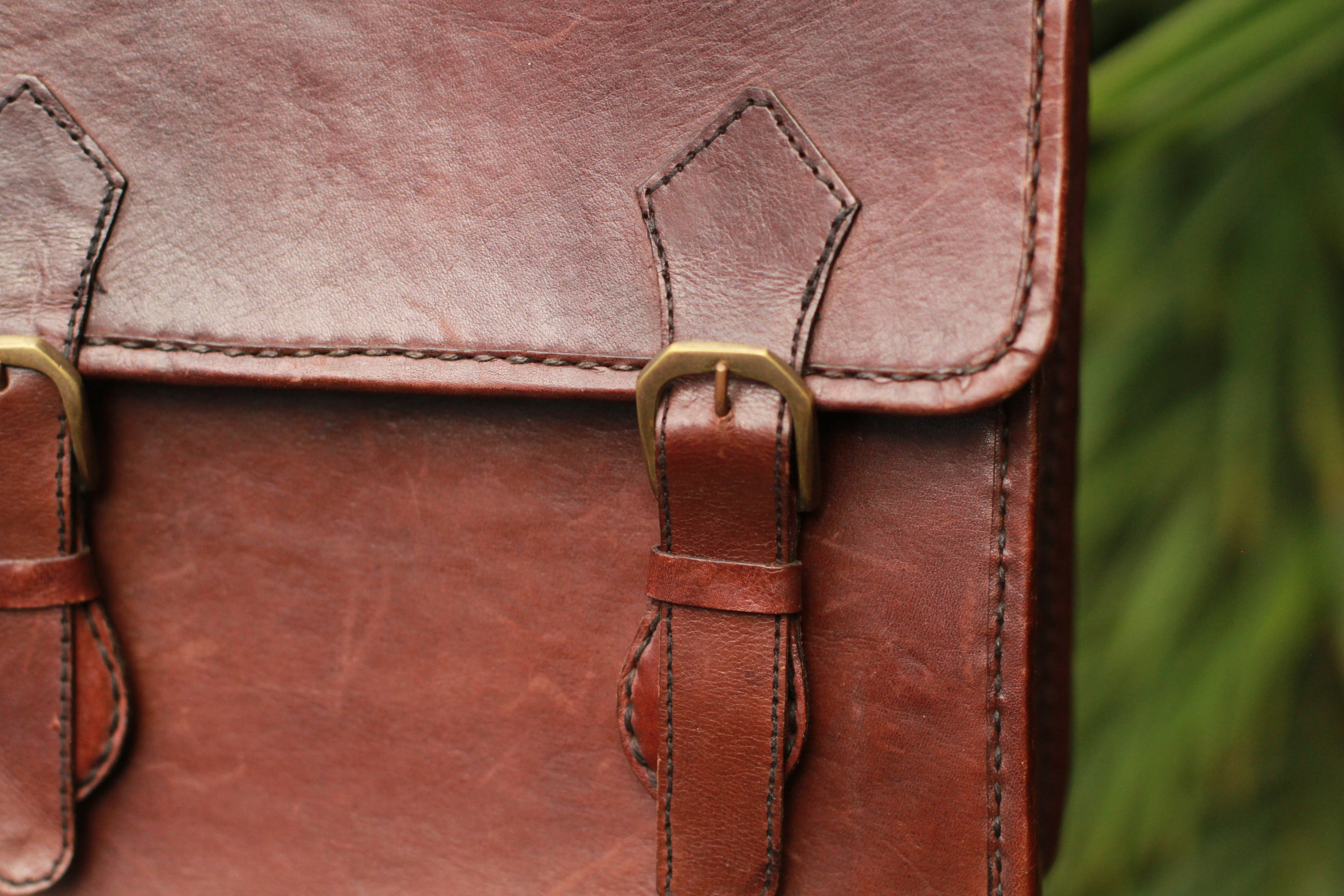 Brass hardware closure on Vintage dark brown leather messenger bag