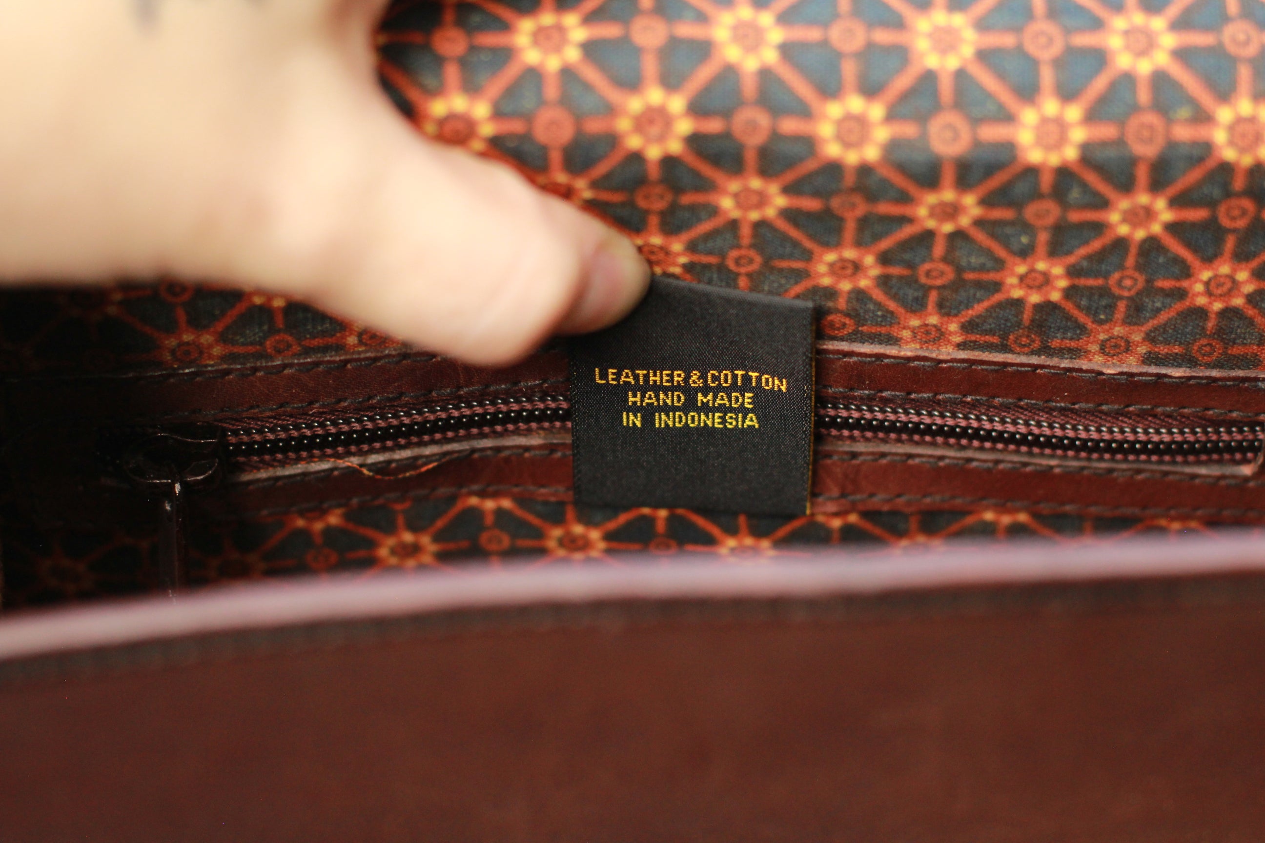 Close-up of a leather and cotton product with 'Made in Indonesia' label