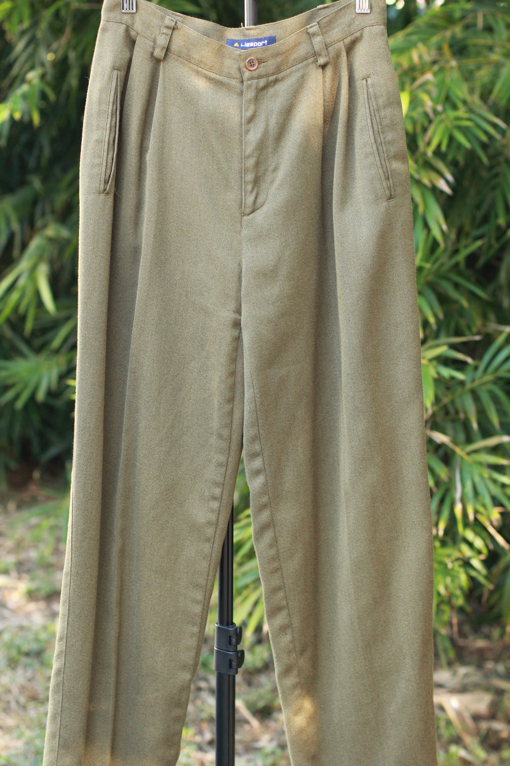 Front view of retro tailored 90s trousers with side pockets