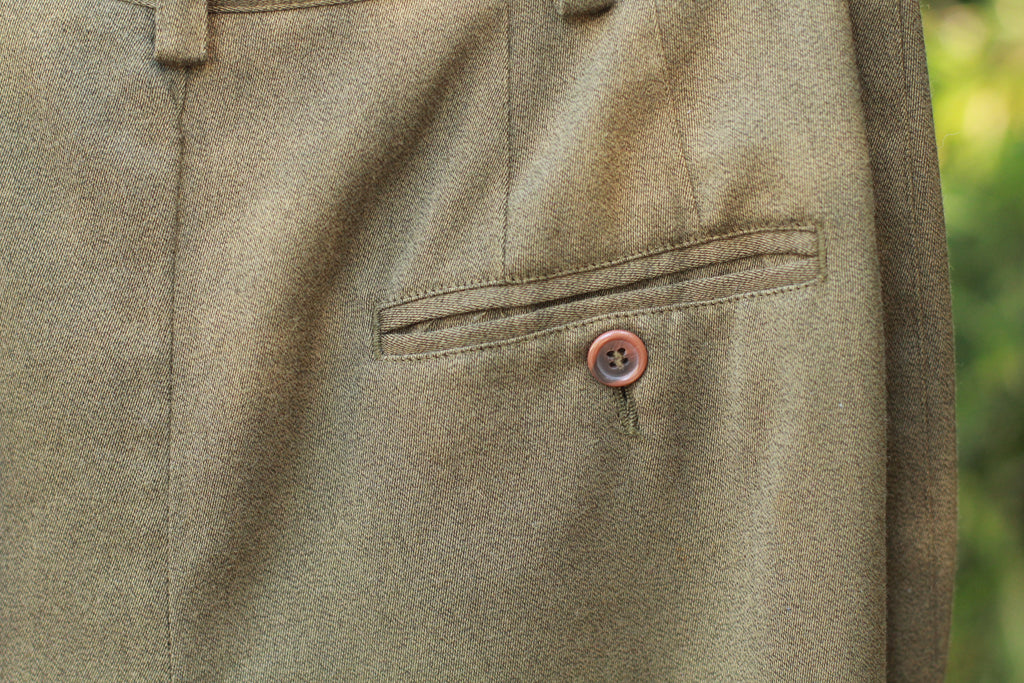 Close-up of buttoned rear pocket detail on vintage pants