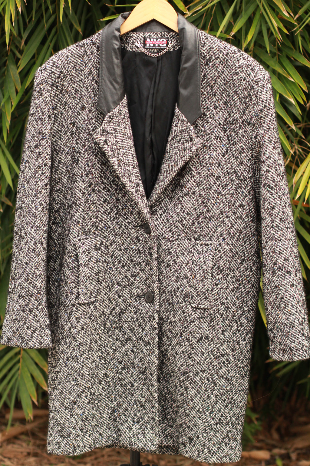 Vintage black and white herringbone tweed women’s coat with leather lapels, 1980s