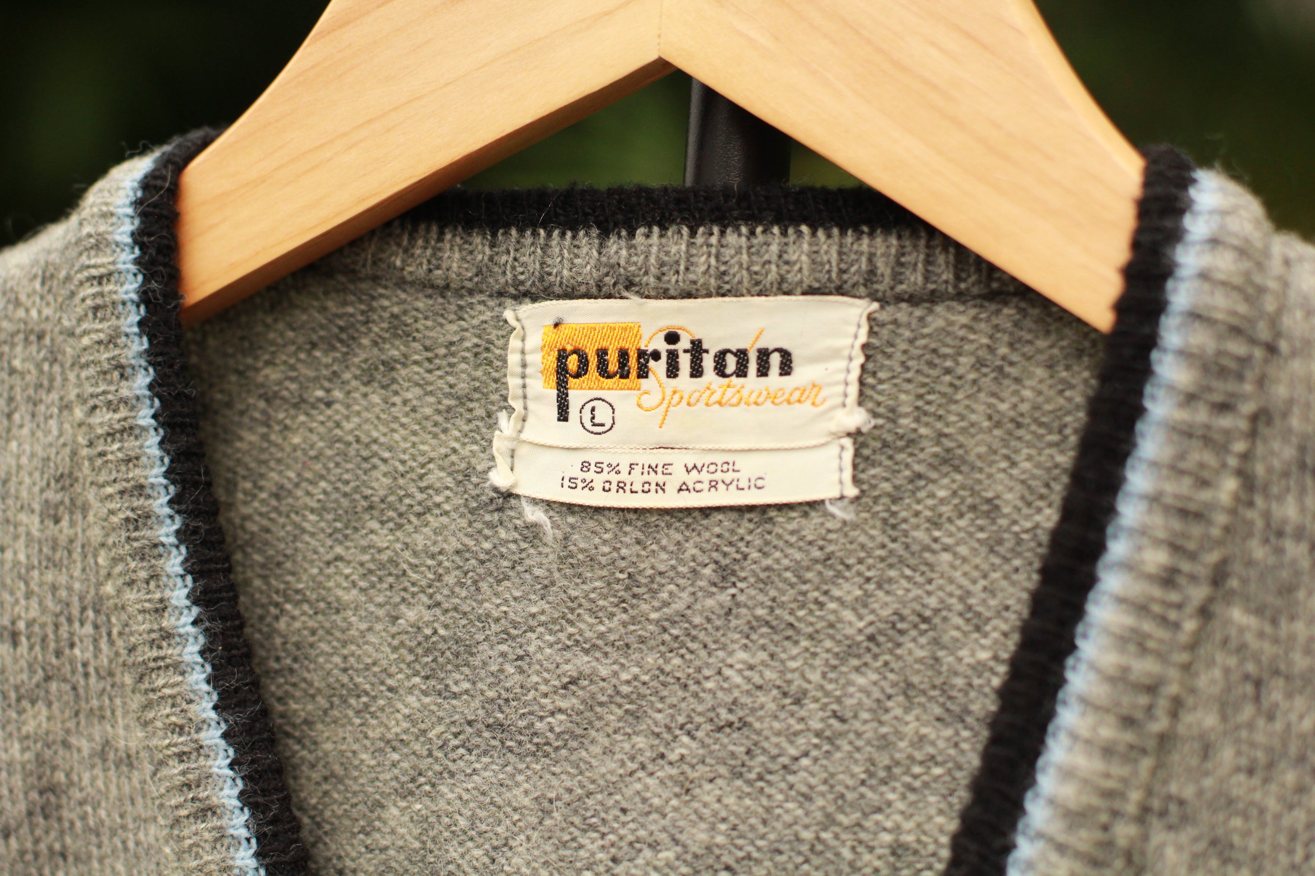 Vintage 1960s gray wool sweater vest with black and light blue V-neck trim