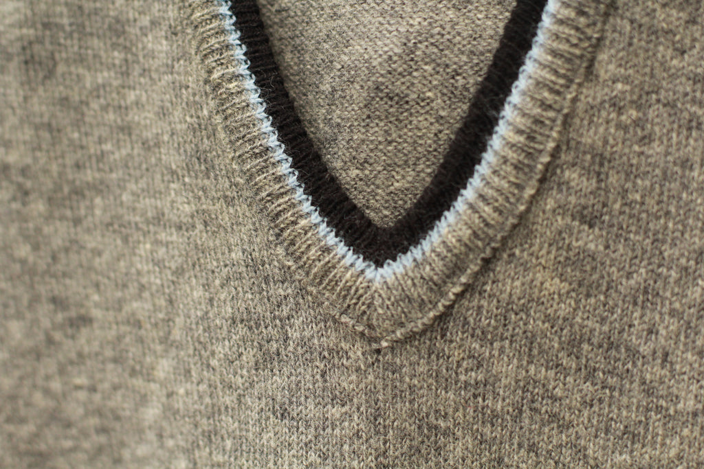 Close-up of V-neck trim detail and knit texture on vintage vest