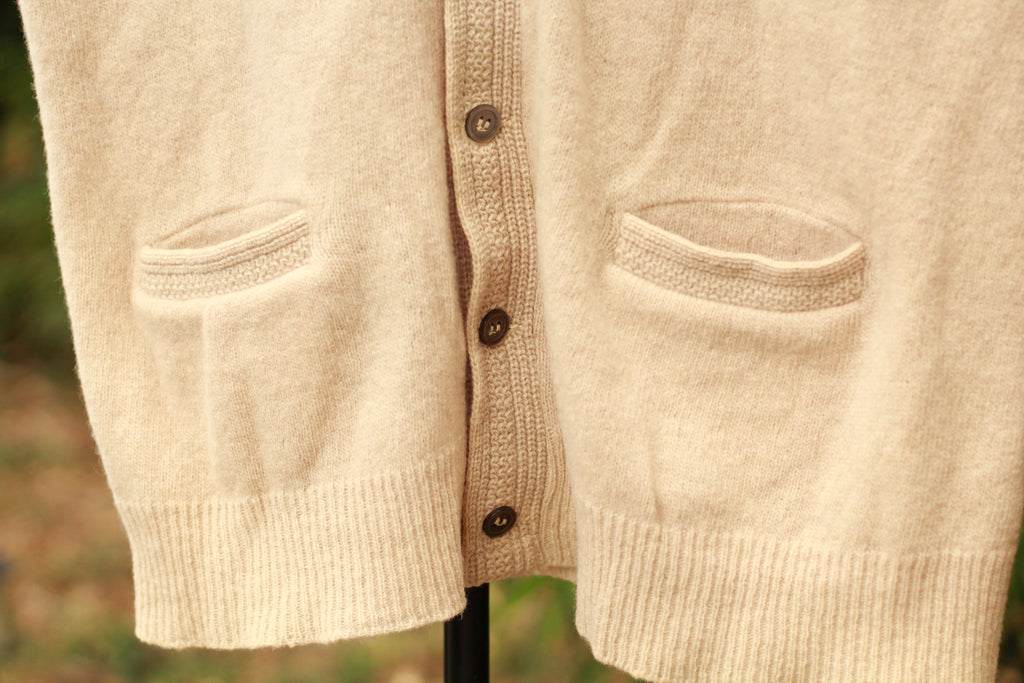 Close-up of knit texture and button detail on vintage sweater vest