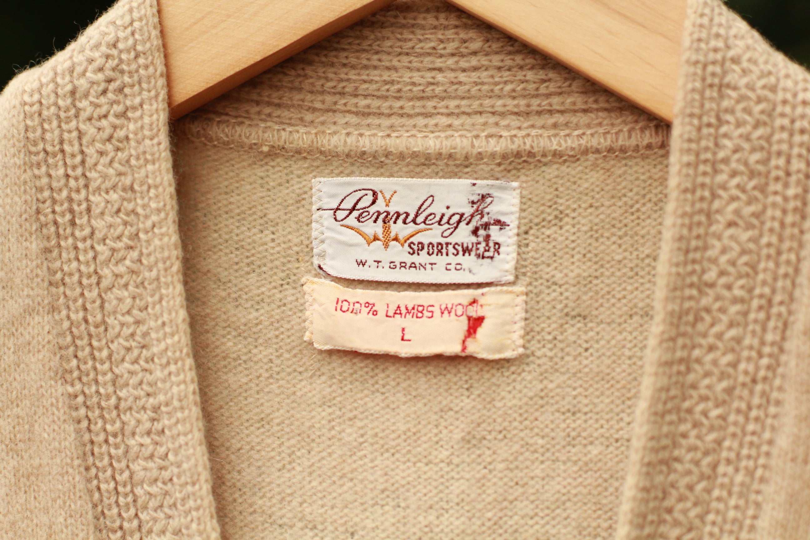 Close-up of knit texture and brand tag on vintage sweater vest