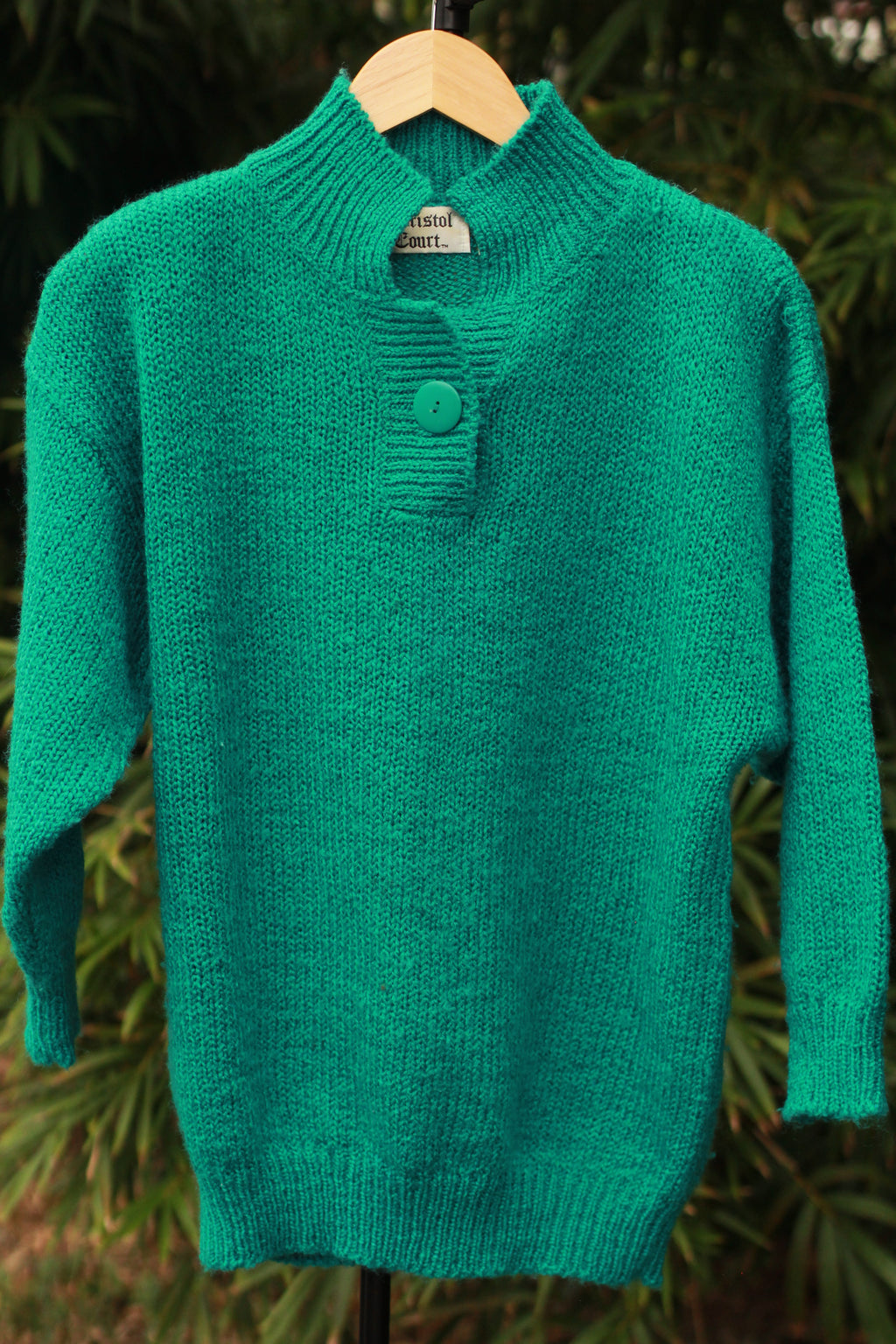 Front view of Bristol Court 80s sweater with single button closure and shoulder pads