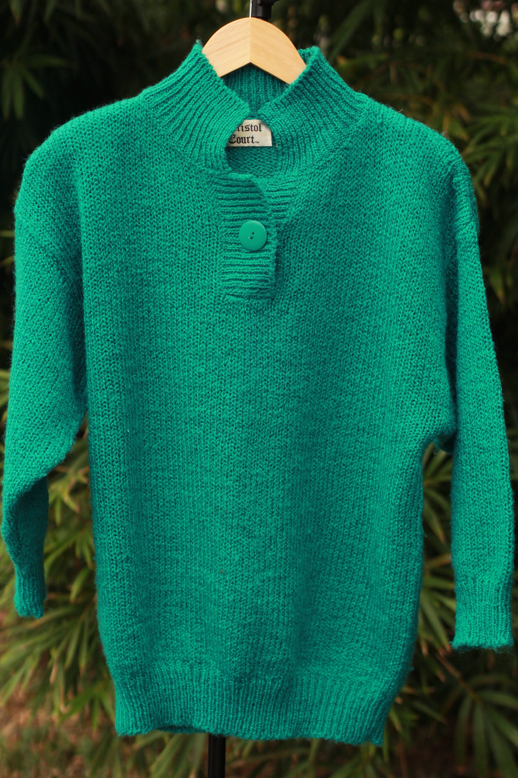 Front view of Bristol Court 80s sweater with single button closure and shoulder pads