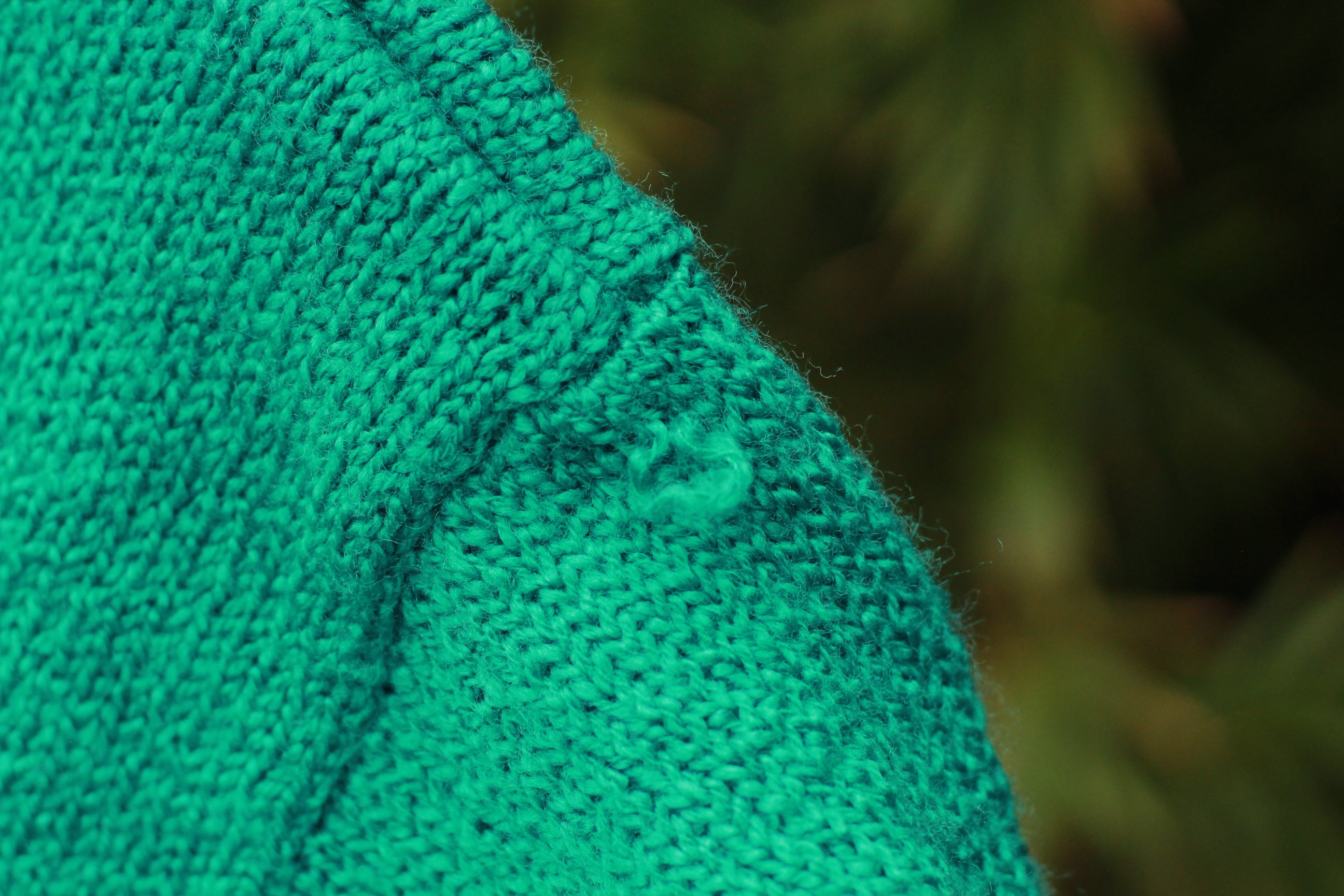 Close-up of knit texture and minor pulling on vintage 80s sweater