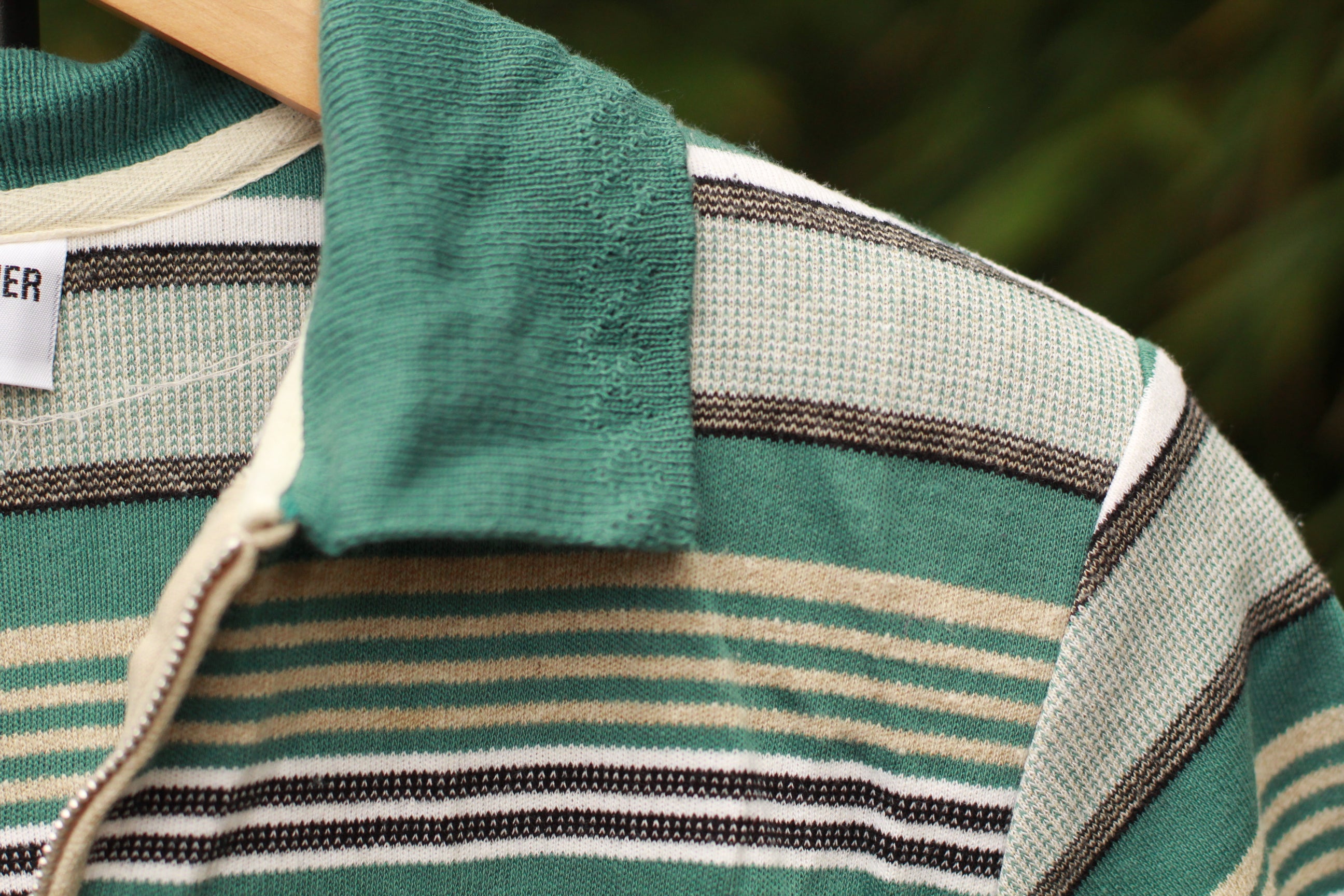 Close-up of shoulder pad and zip polo neckline detail