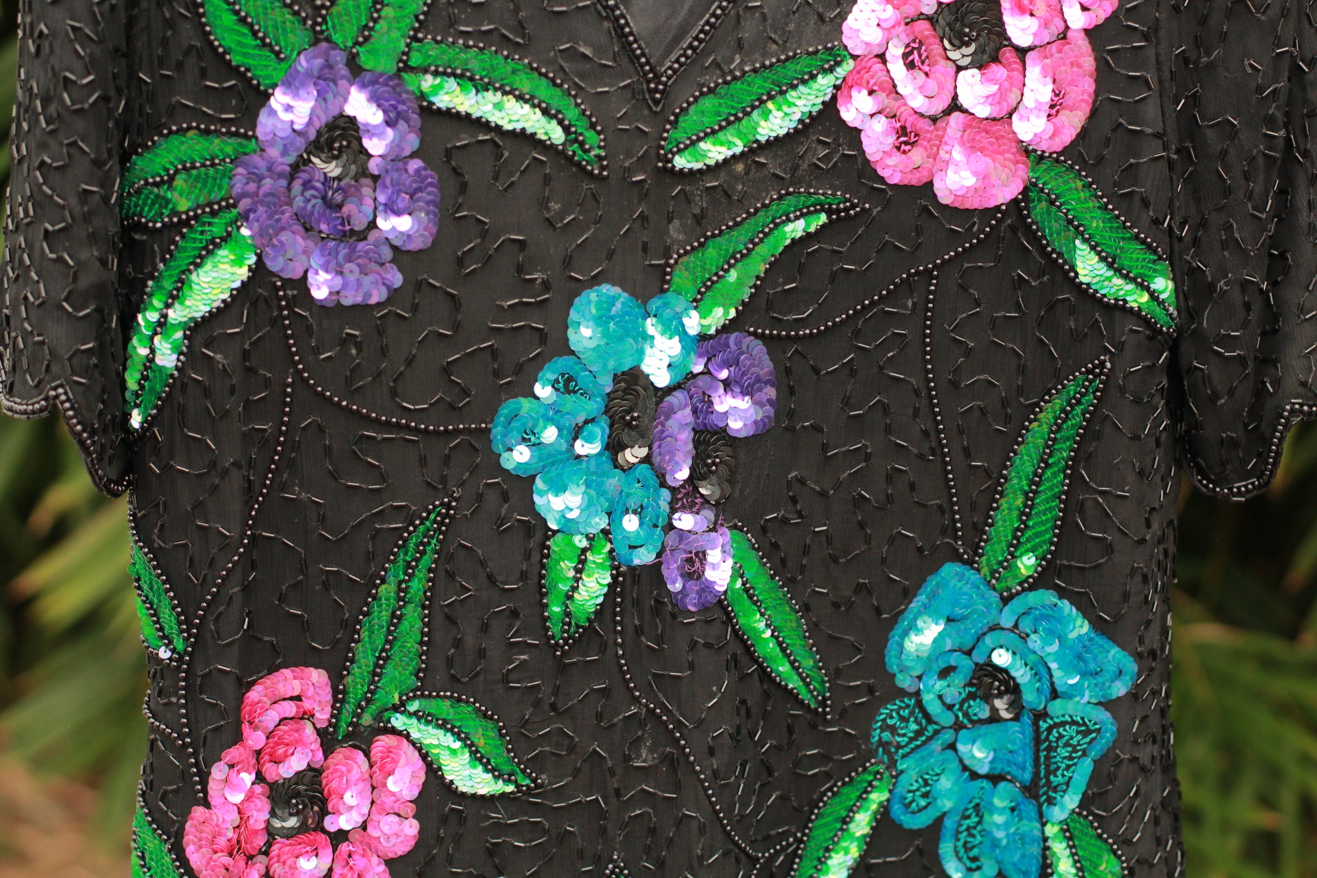Close-up of multi-colored floral sequins and bead embellishment on vintage top, Missing sequins on purple flower