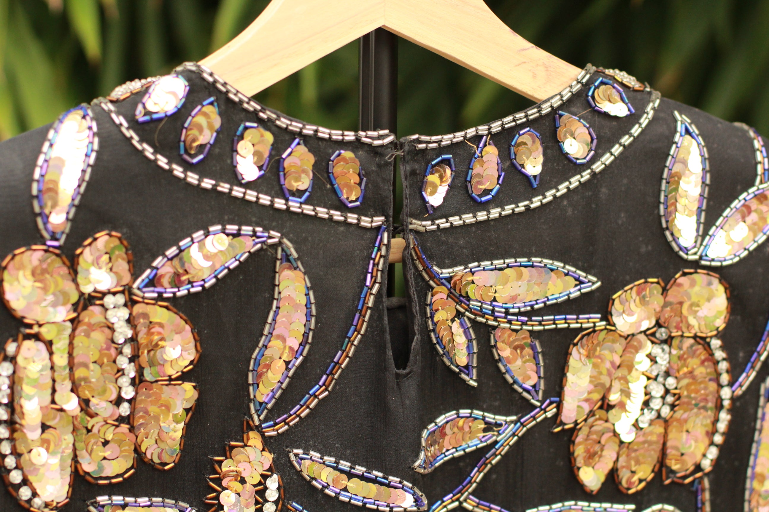 Back view showing dual hook-and-eye closures and shoulder pads