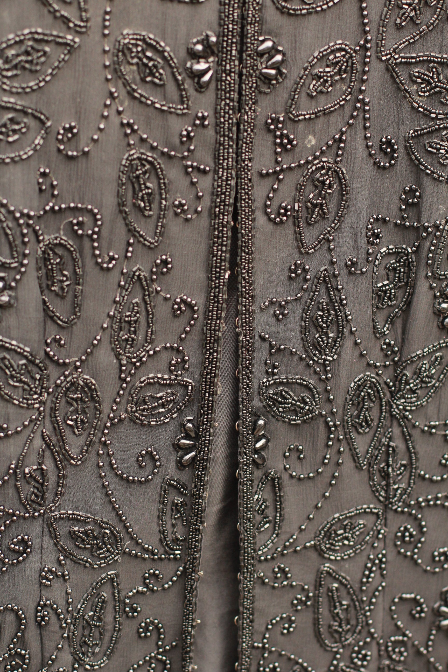 Detail of 18 hook-and-eye front closures on vintage jacket