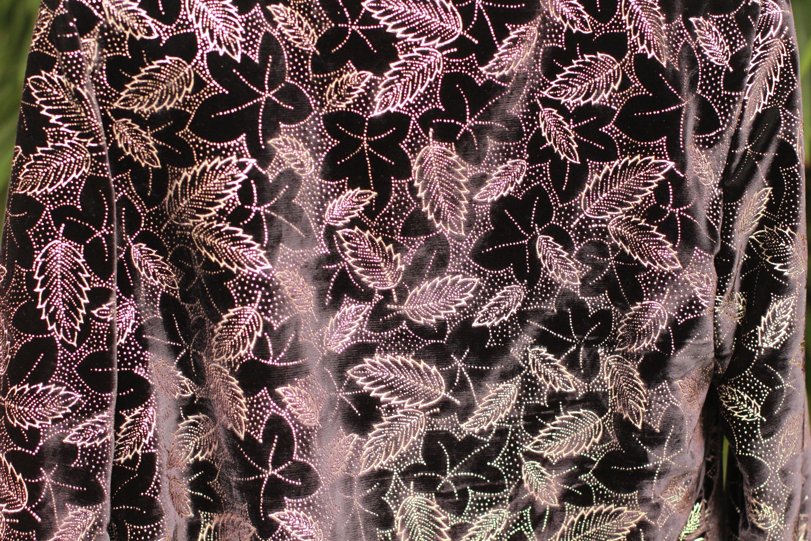 Close-up of glittery pattern and velvet texture on 1980s statement jacket