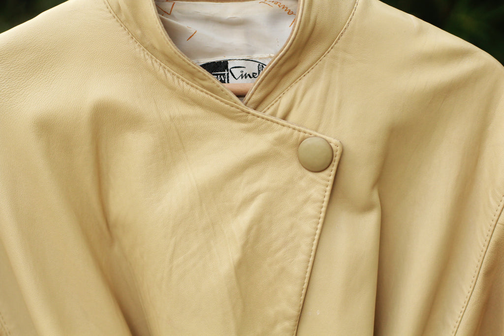 Close up of button closure on vintage beige Paris-Made jacket