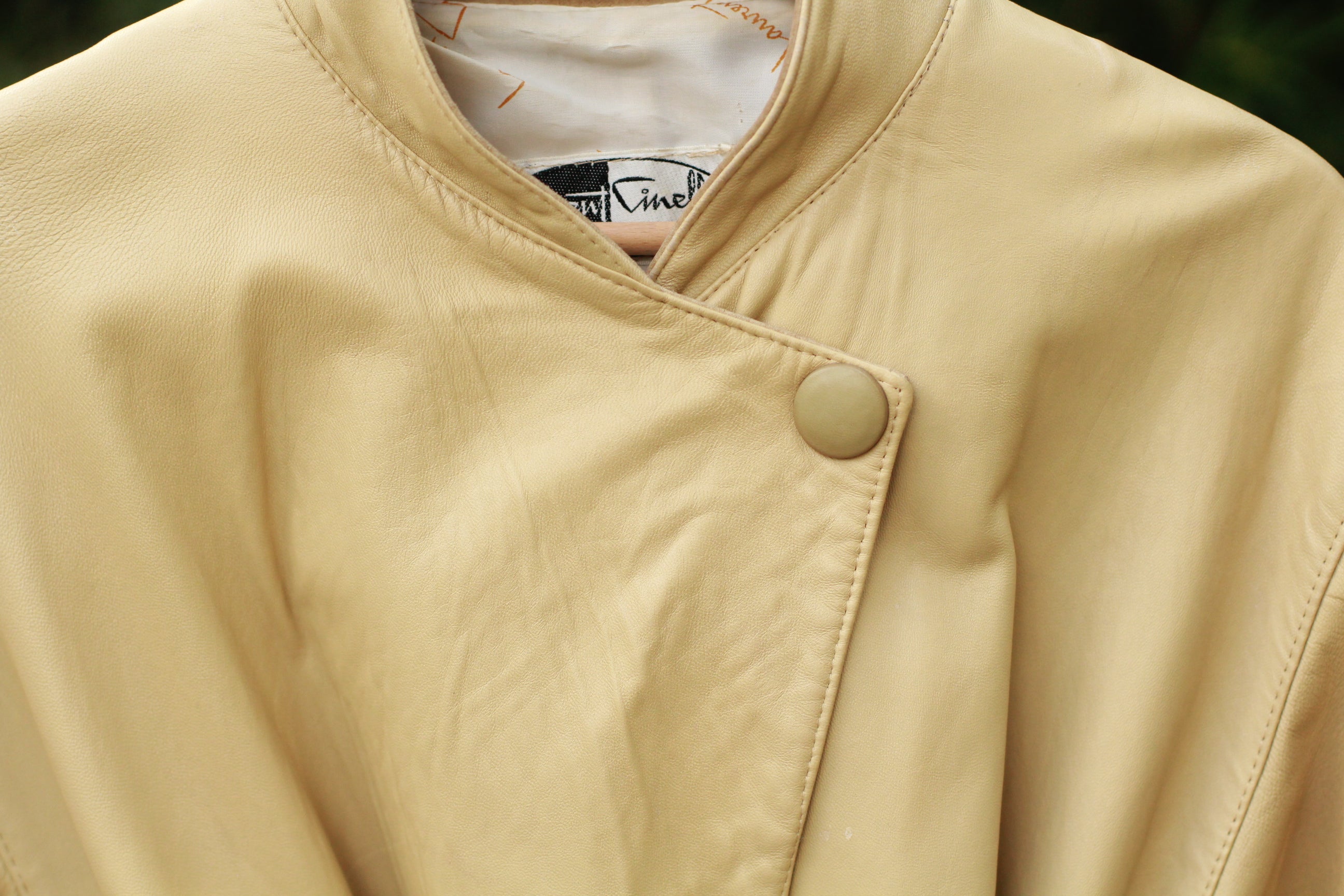 Close up of button closure on vintage beige Paris-Made jacket