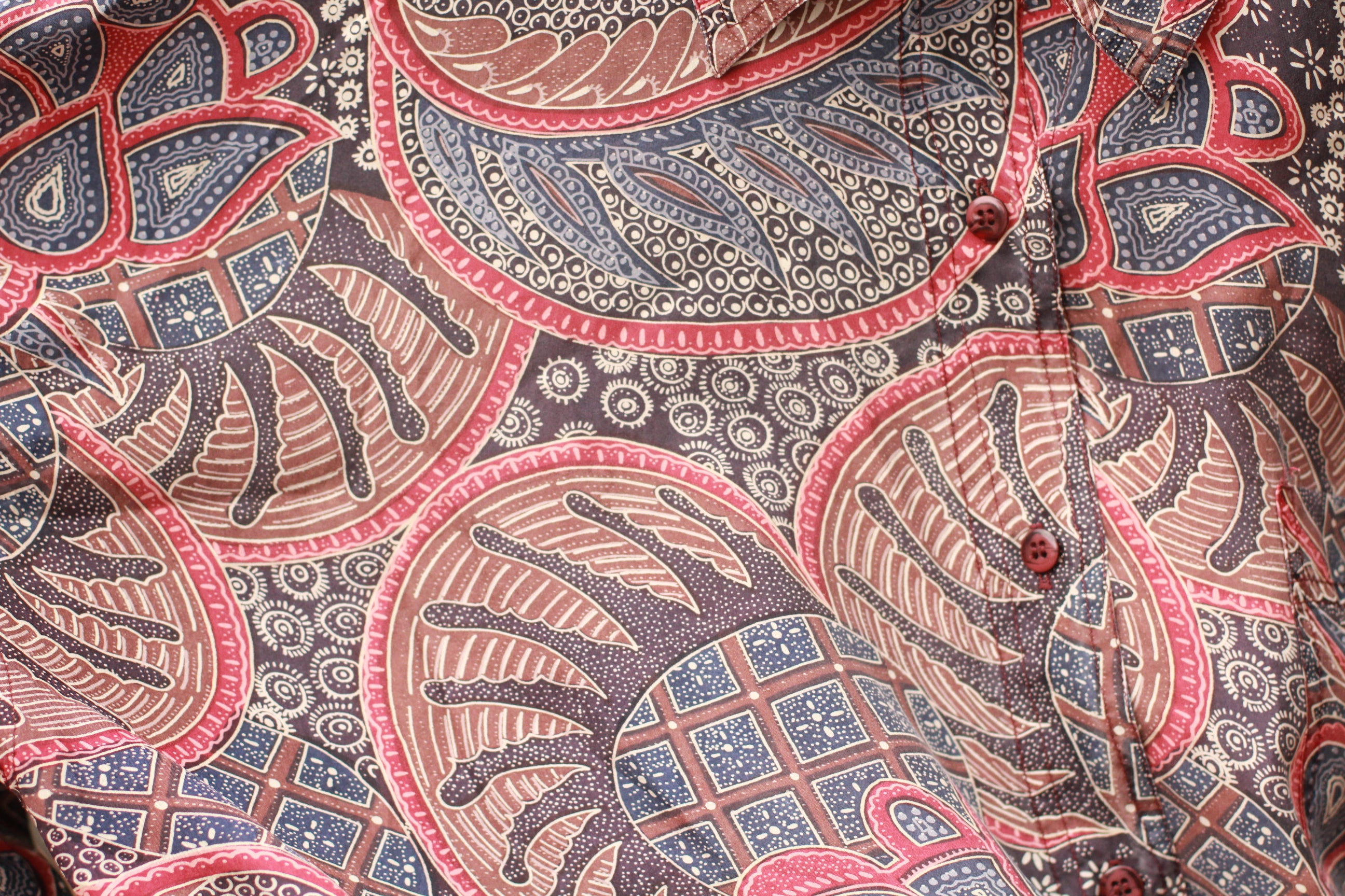 Close-up of buttons and paisley pattern on Cristina silk blouse