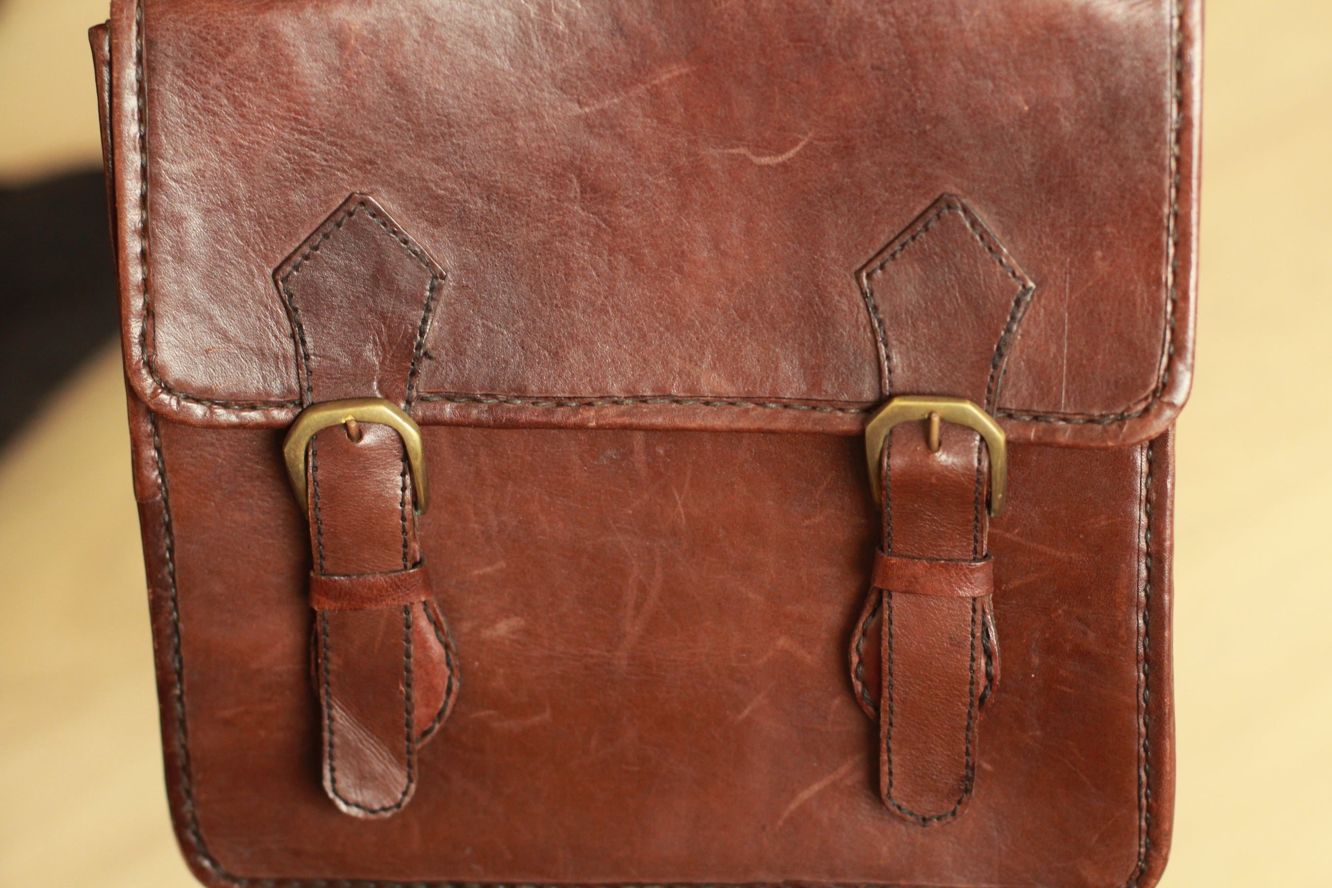 Close-up showing minor scratches and natural leather patina