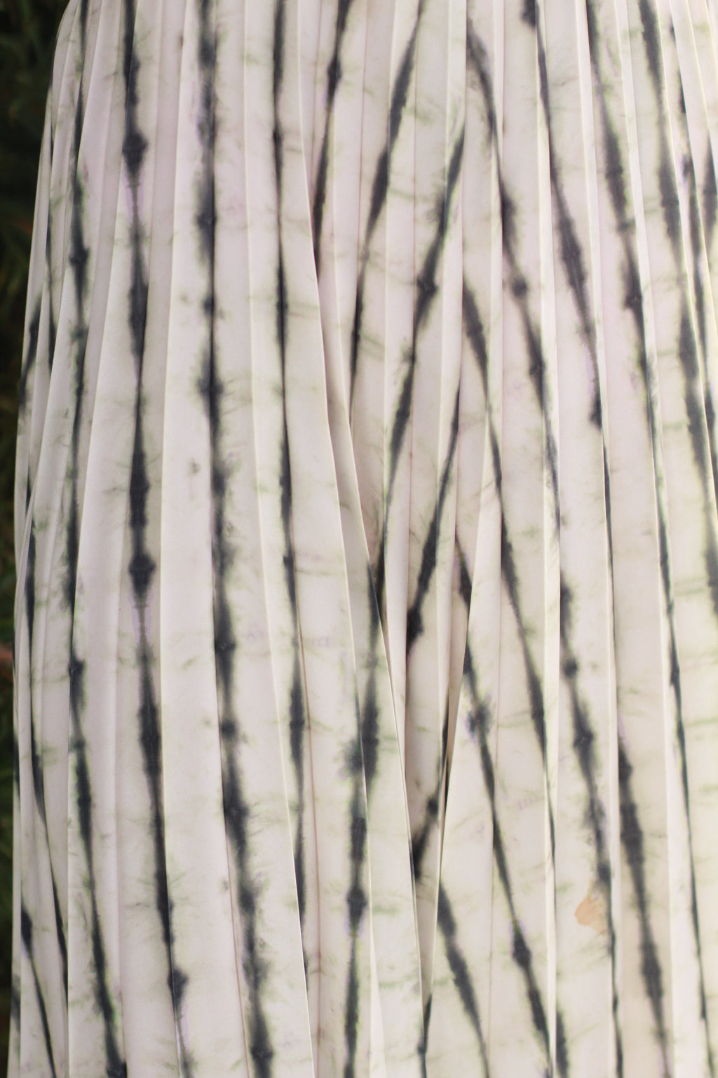 Close-up of tie-dye print and pleats