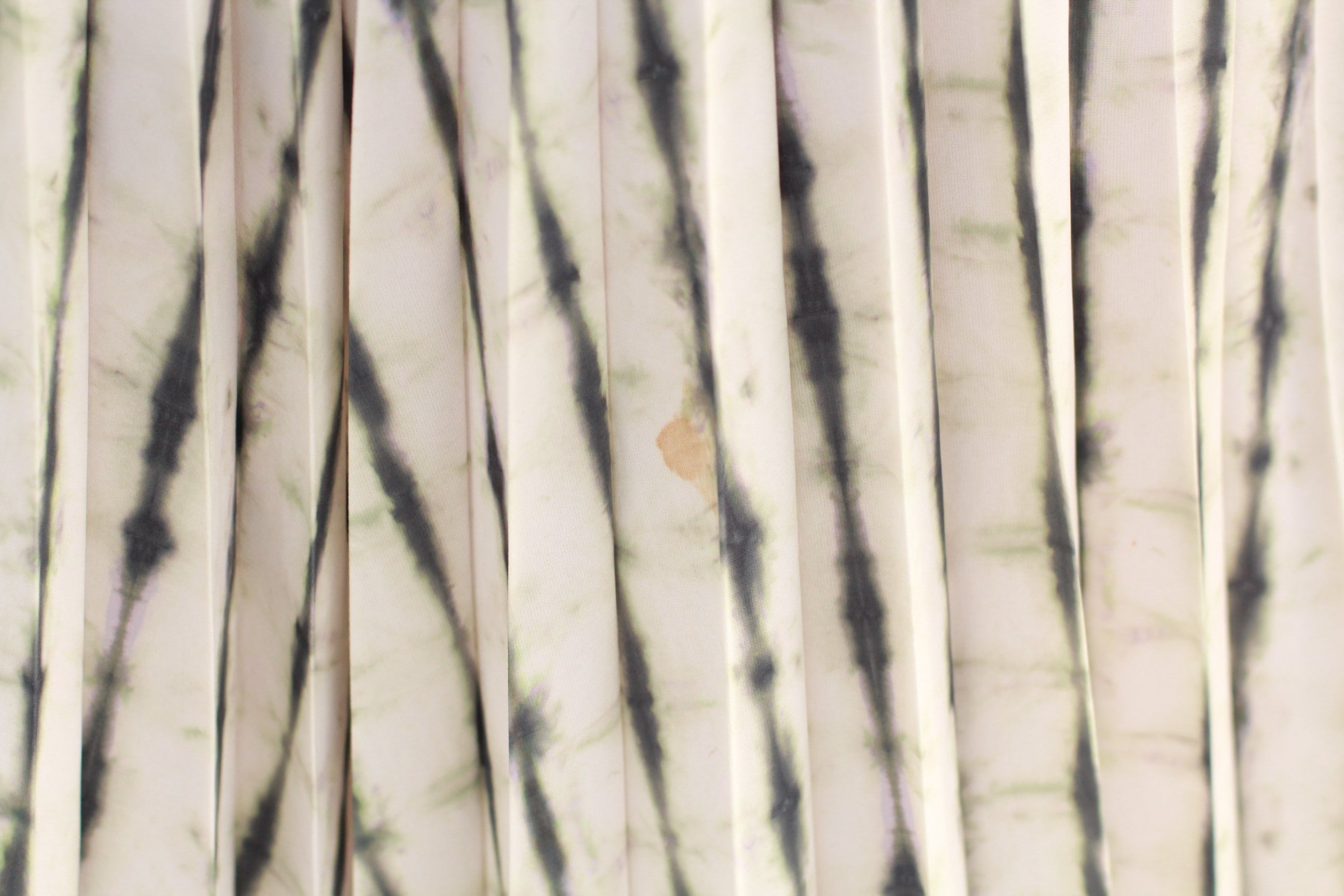 Close-up of minor stain on front of skirt in different lighting