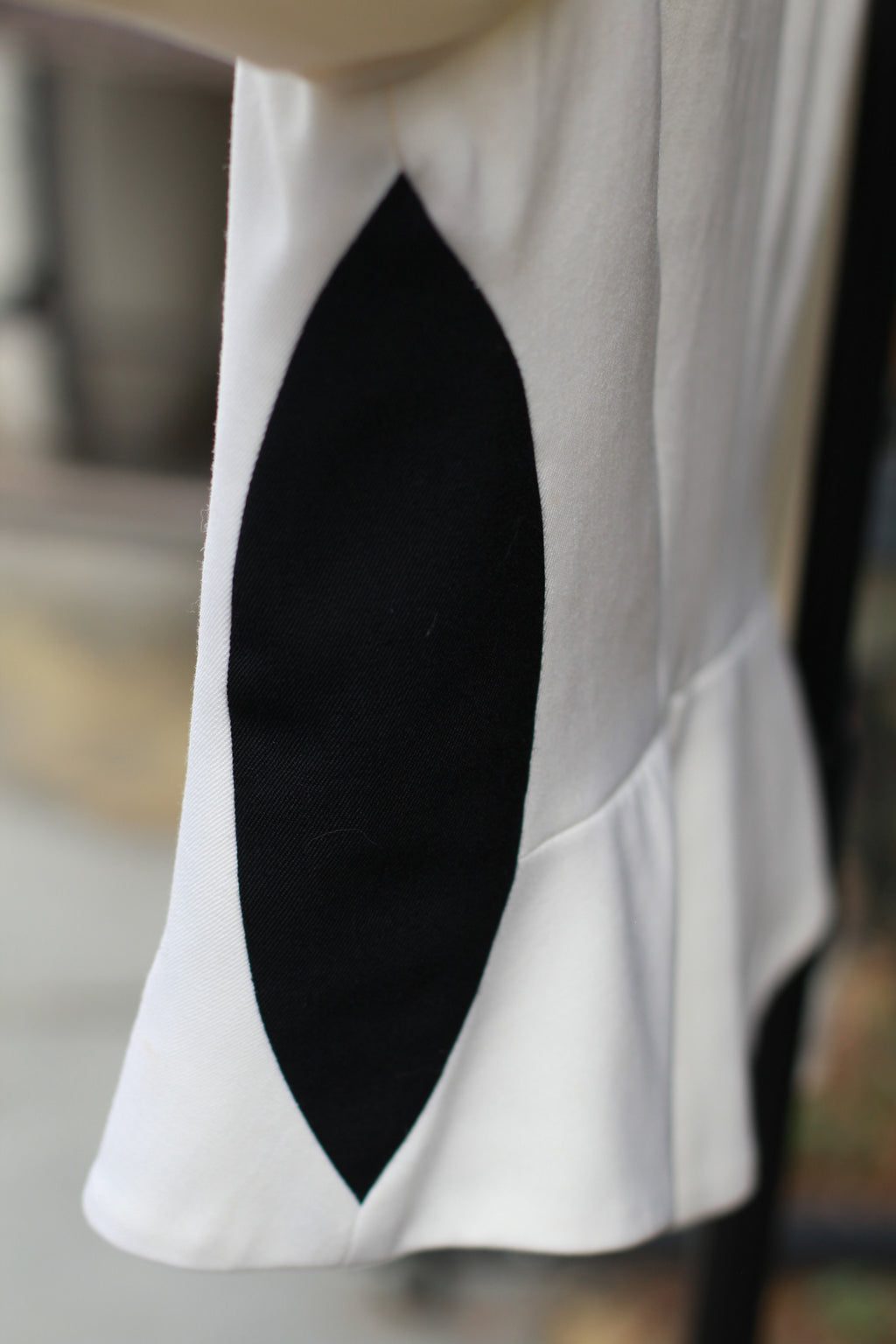 Side view of lack paneling on vintage CACHÉ jacket.