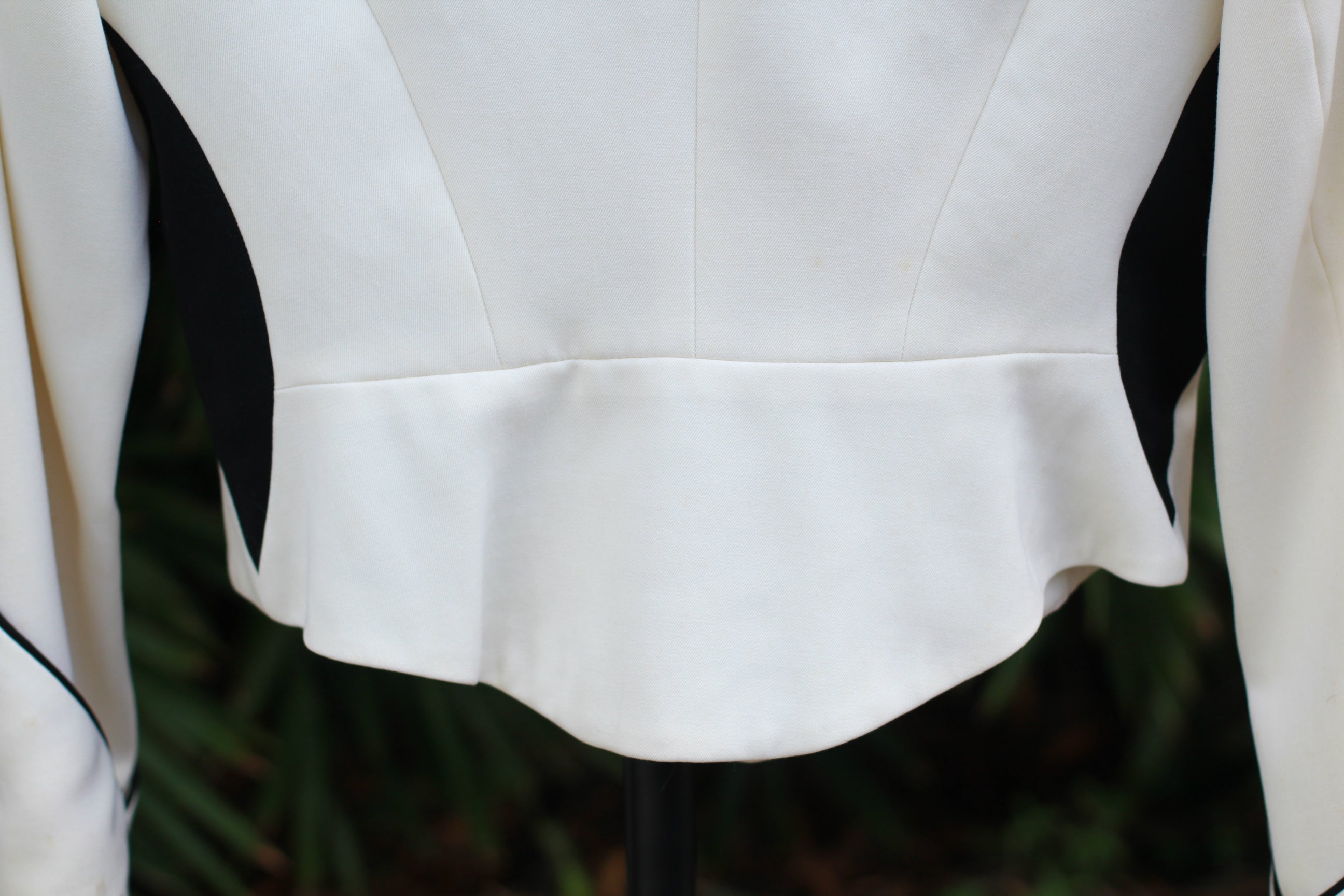 Back view of bottom hem on vintage CACHÉ jacket.