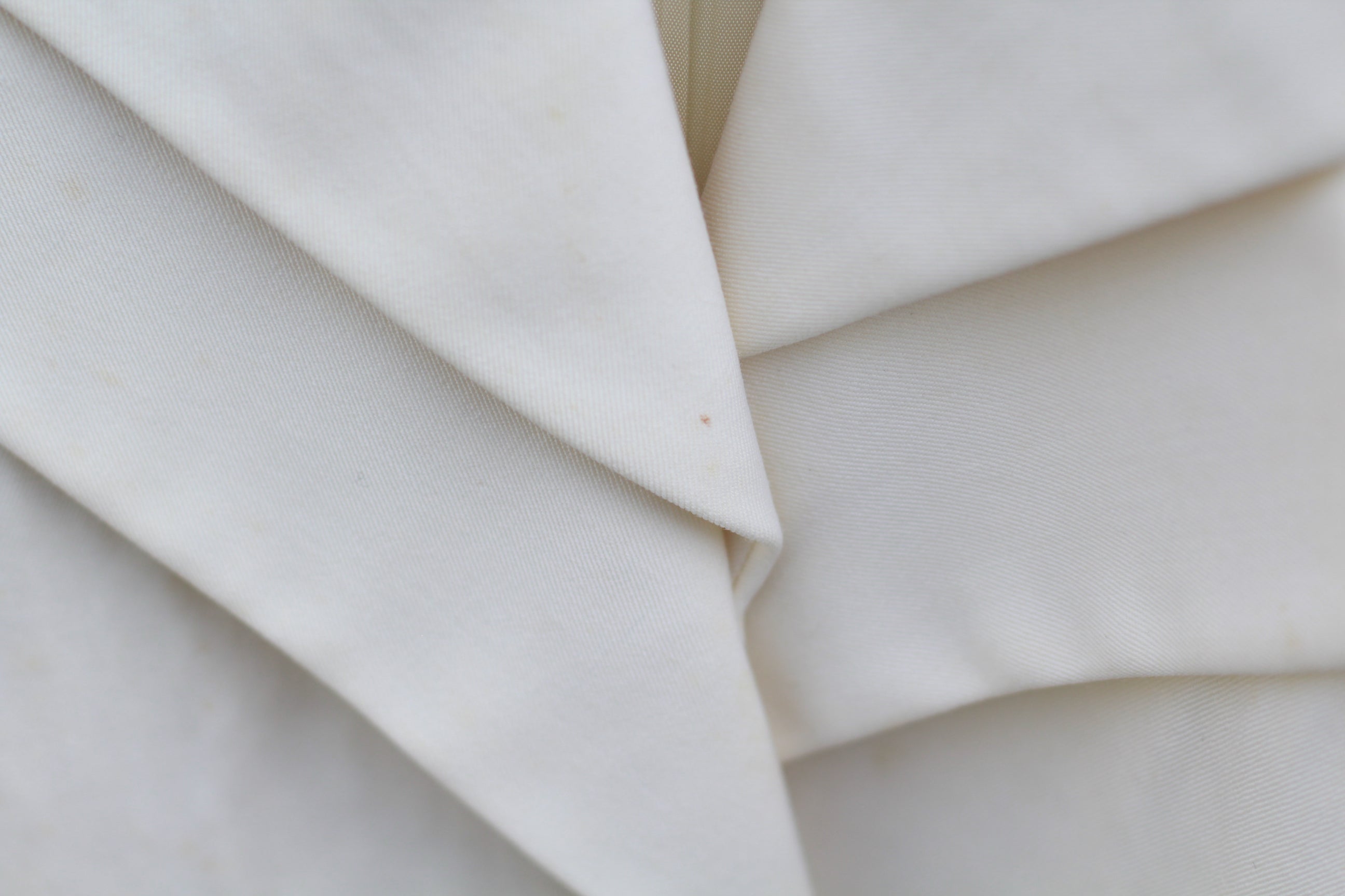 Photographed marks and small stains on vintage cream wool jacket.