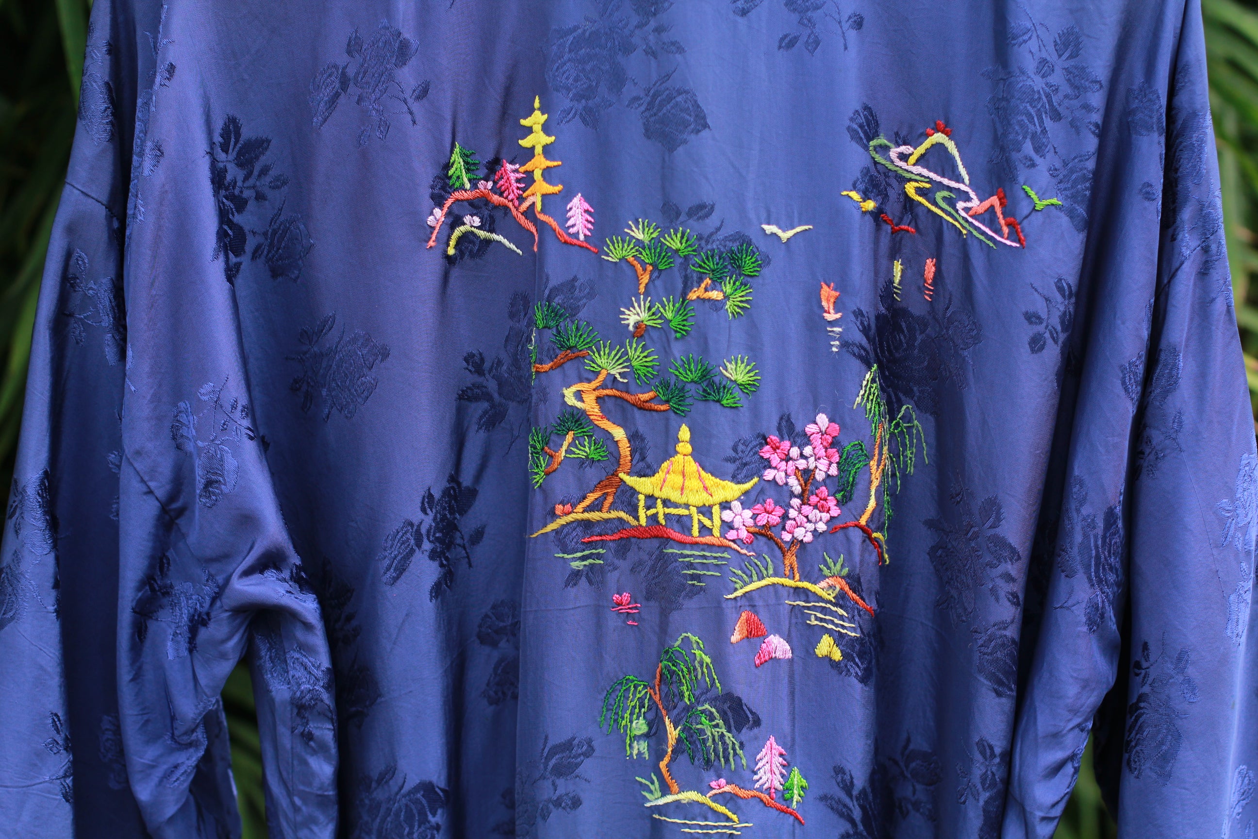 Detail of hand-stitched dragon design on back of kimono